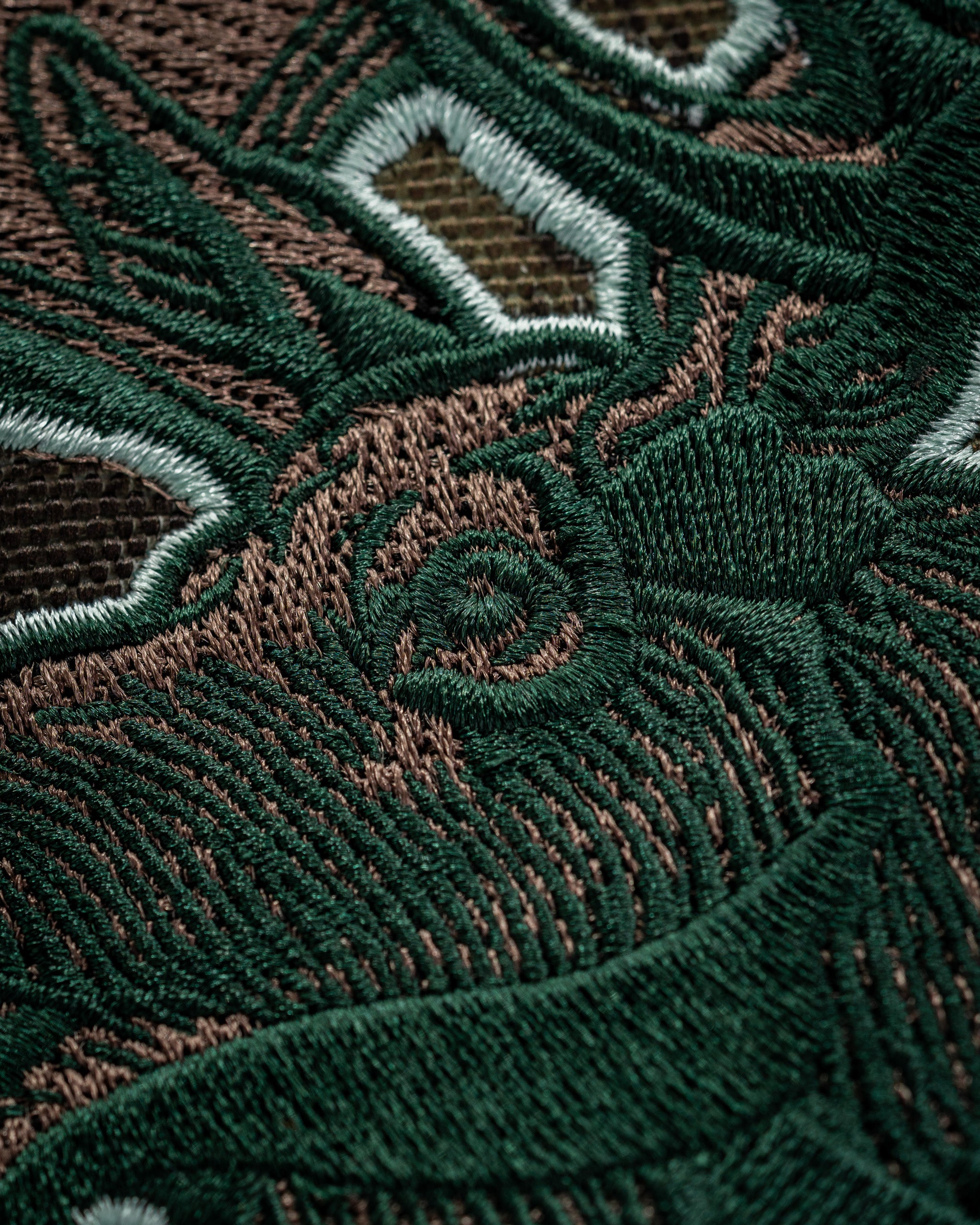 Detailed close-up of a moose design embroidered on a golf driver cover, showcasing intricate stitching and rich colors.