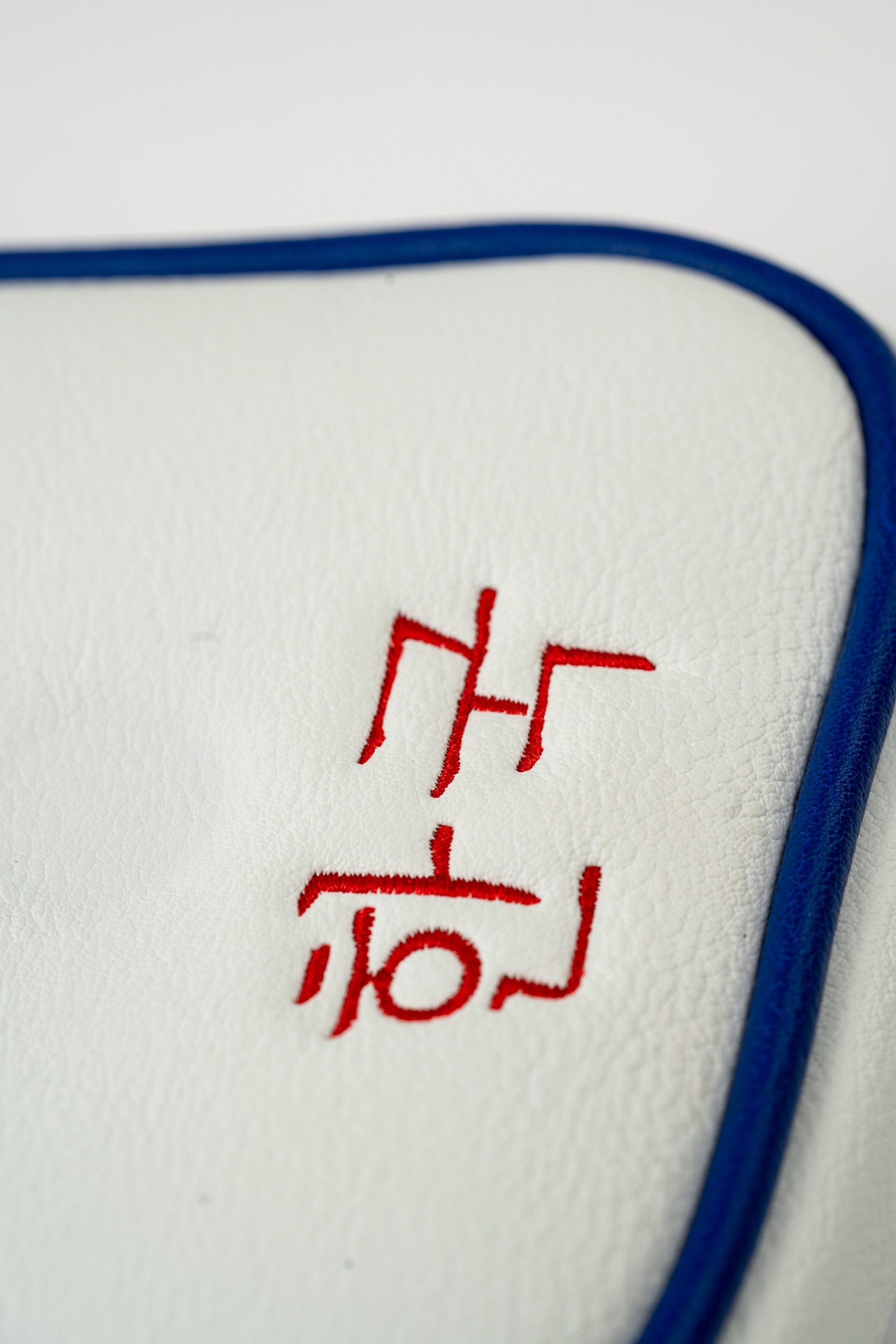 South Korea mallet putter cover featuring bold red embroidery on a white leather background with blue trim.
