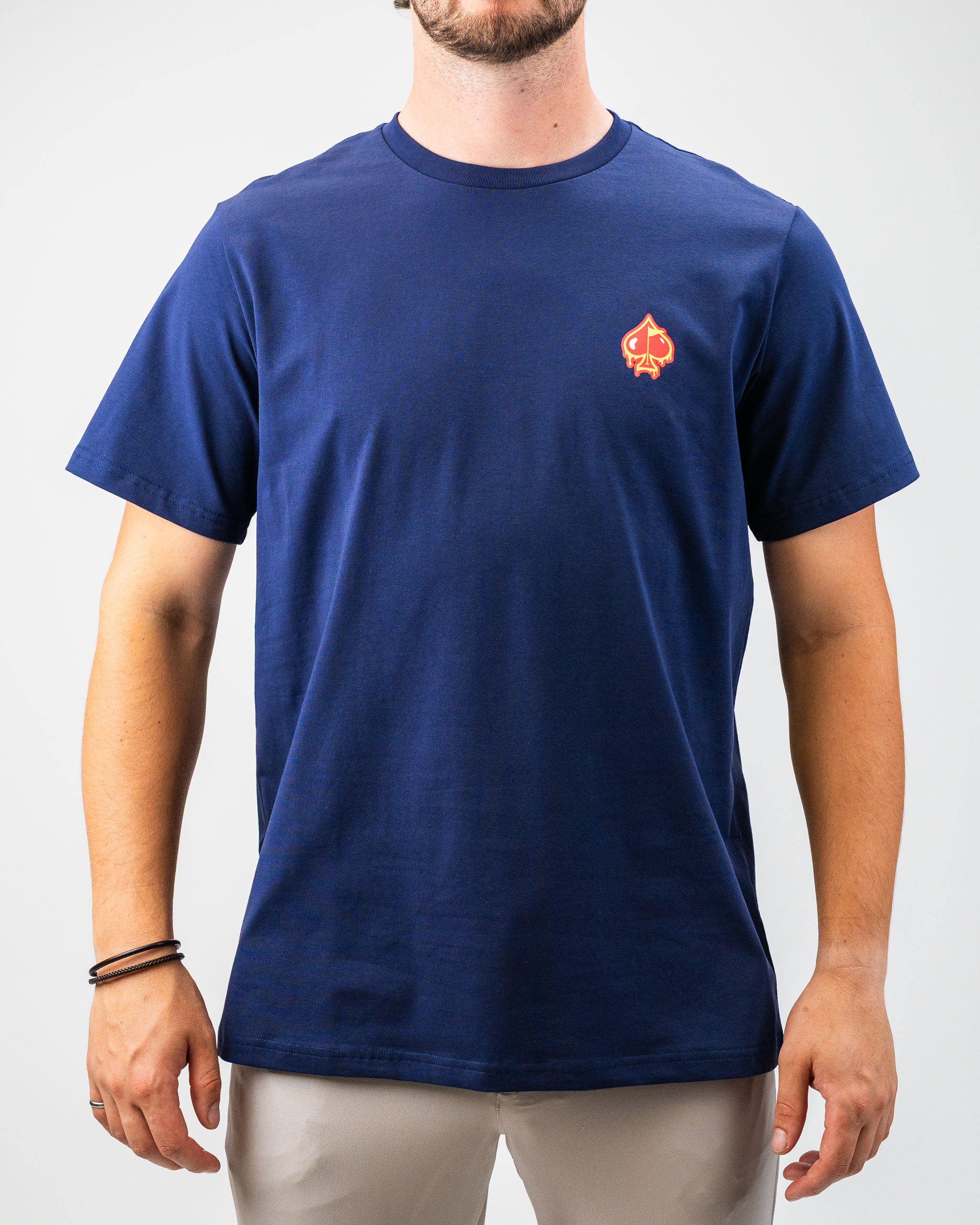 Men's navy blue golf t-shirt with a small red and yellow spade logo on the chest, perfect for bold golf style.