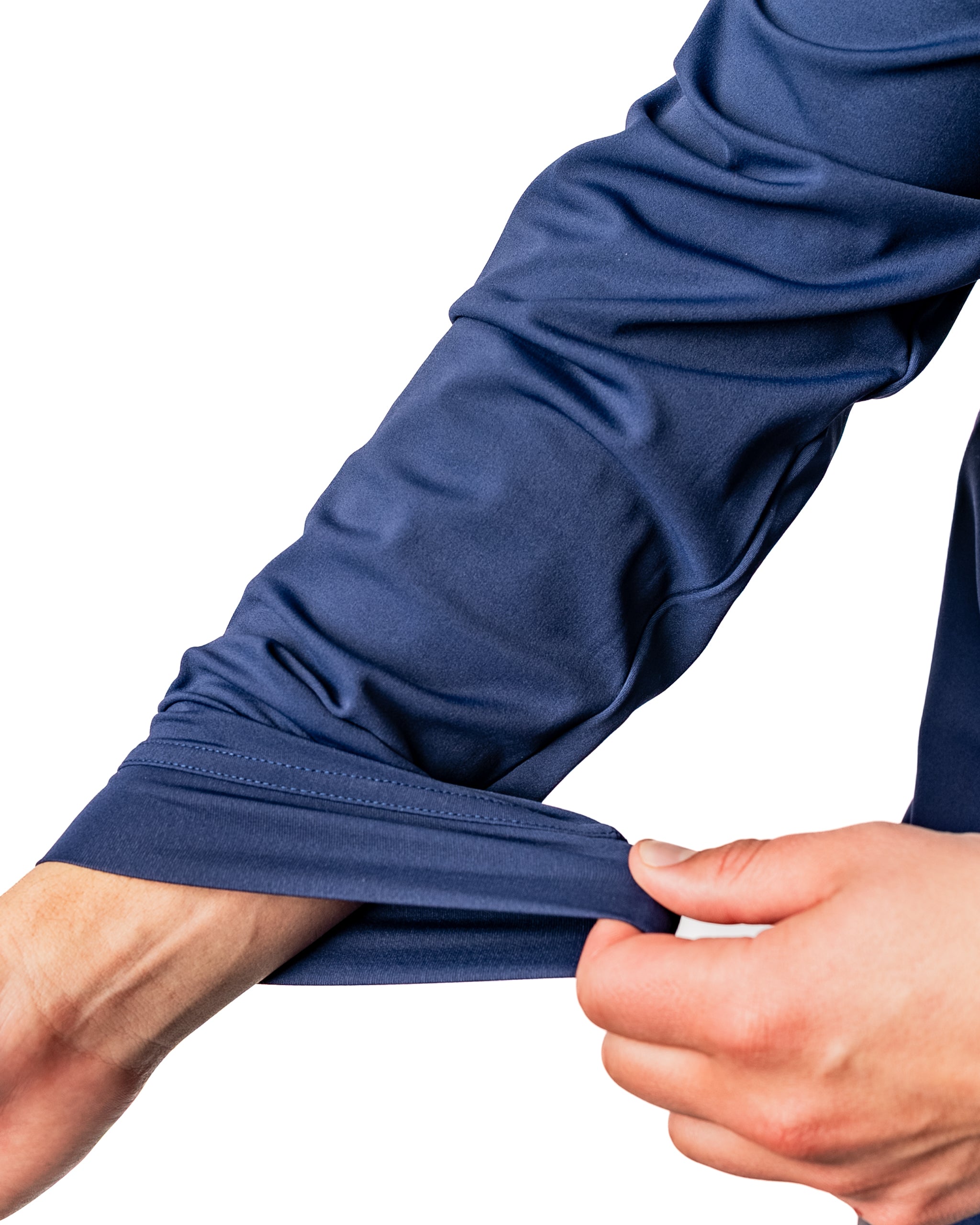 Close-up of a hand pulling the sleeve of a navy performance golf hoodie, showcasing its flexible fabric and design.