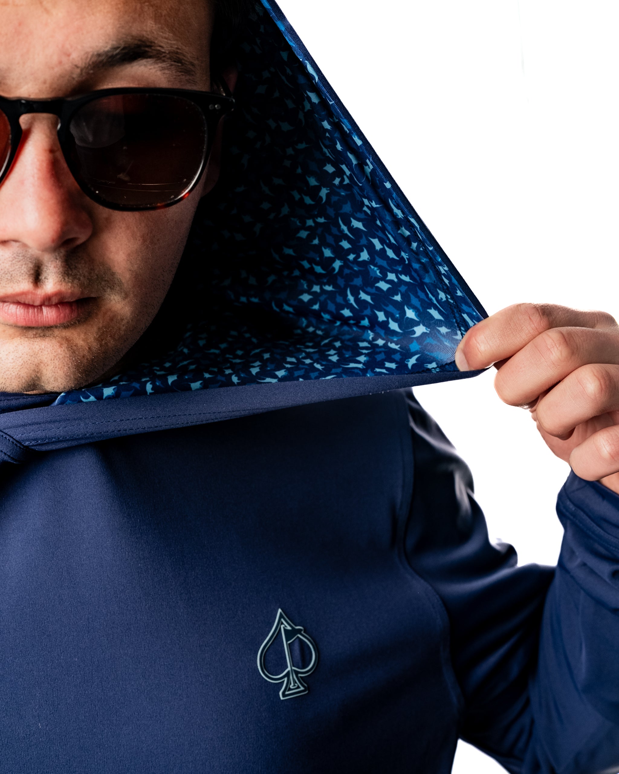 Men's performance golf hoodie in navy with a manta ray pattern lining, designed for comfort and style on the course.