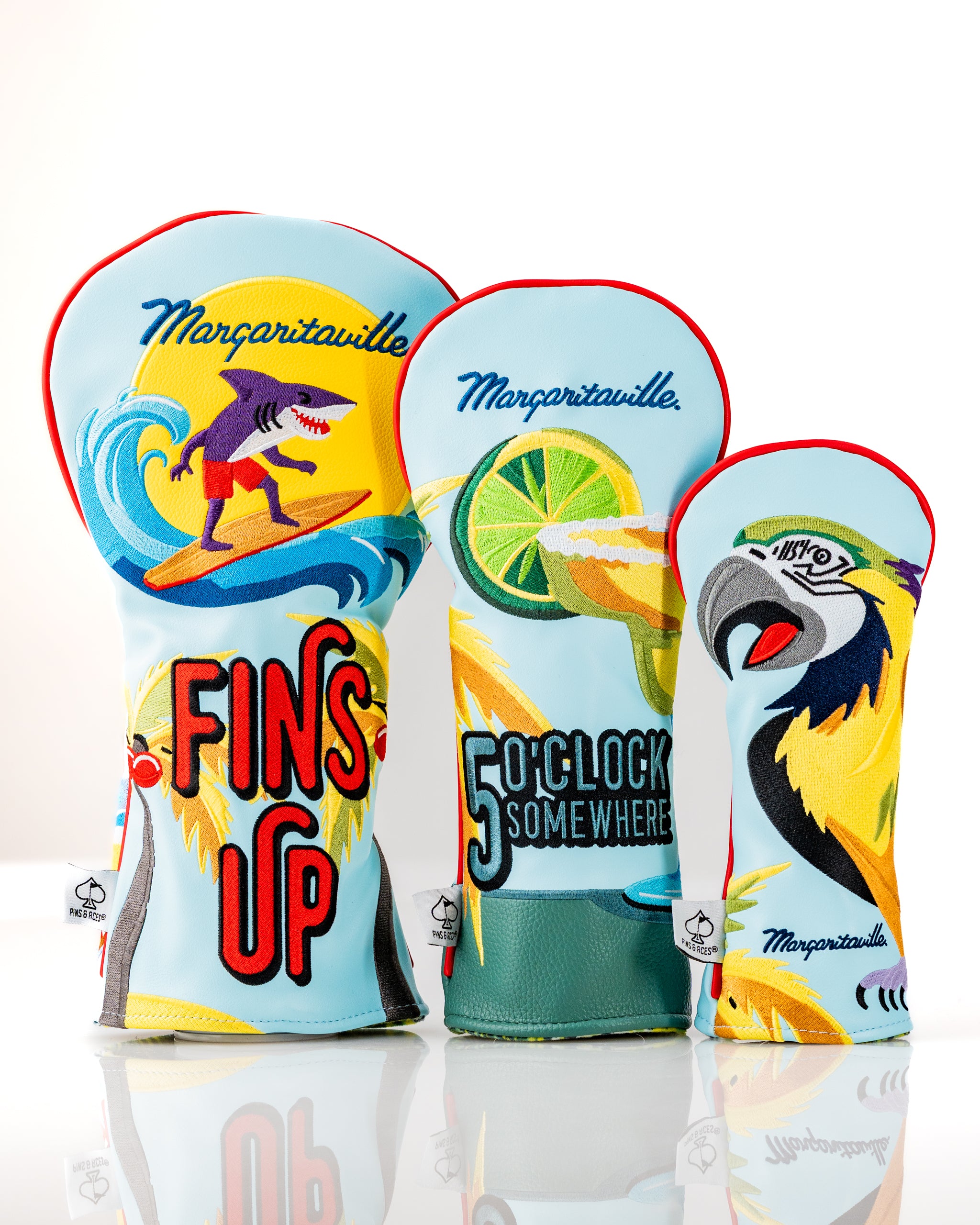 Colorful Margaritaville x Pins & Aces headcover set featuring tropical designs and playful graphics for golf clubs.