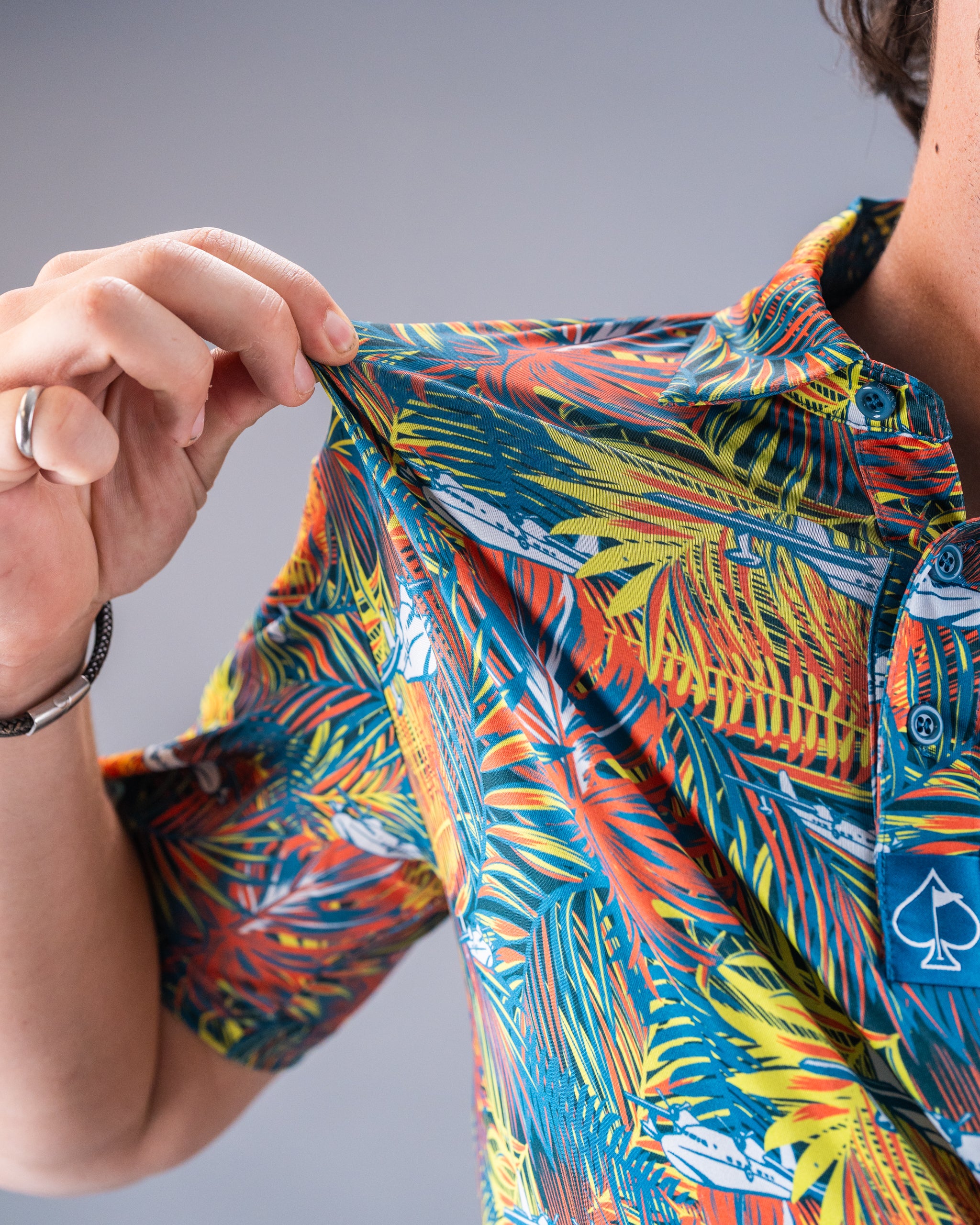 Bold, colorful tropical print golf shirt with button-up front, perfect for making a statement on the course.