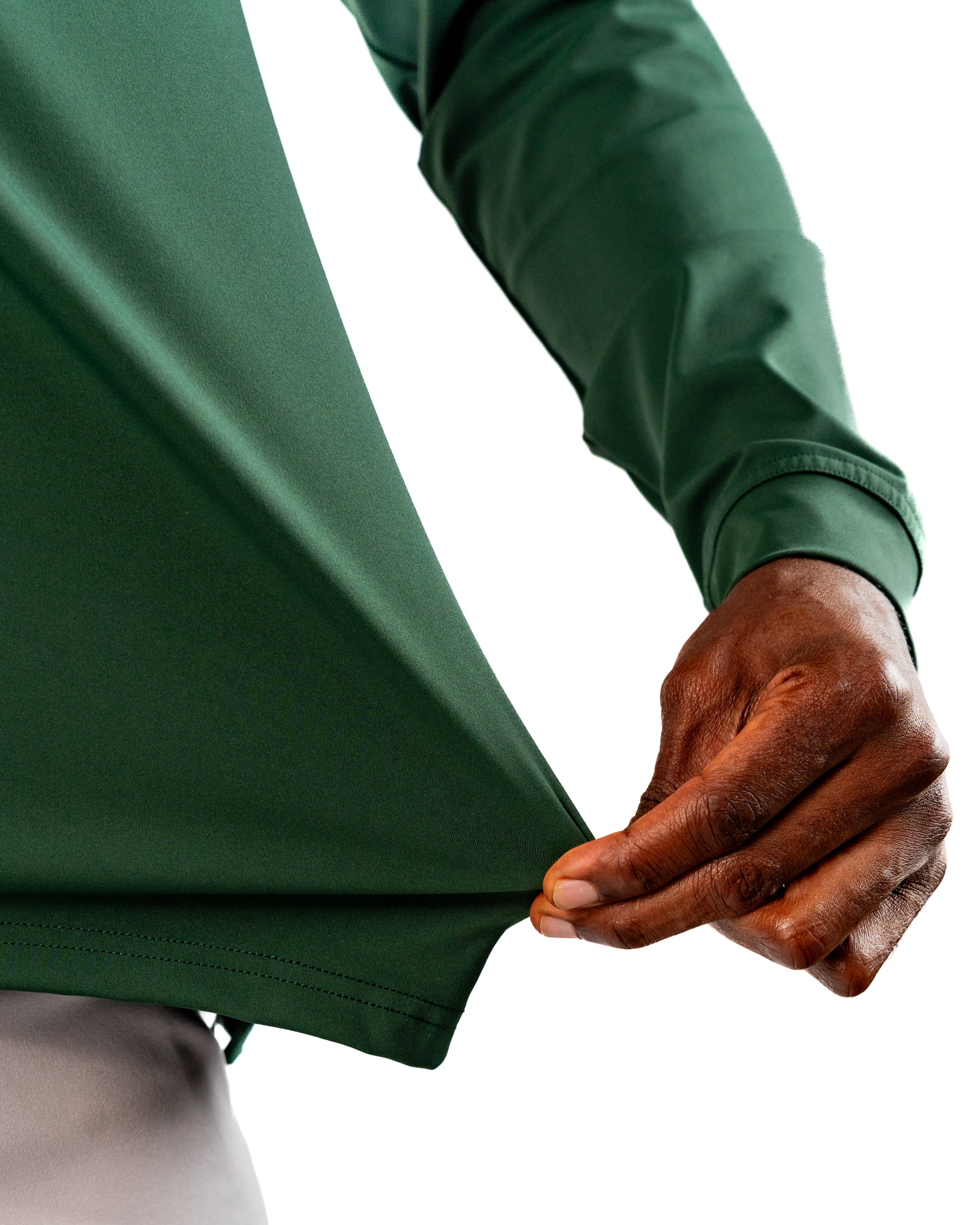 Performance golf hoodie in dark azalea, showcasing a close-up of the fabric being pulled for a flexible fit.