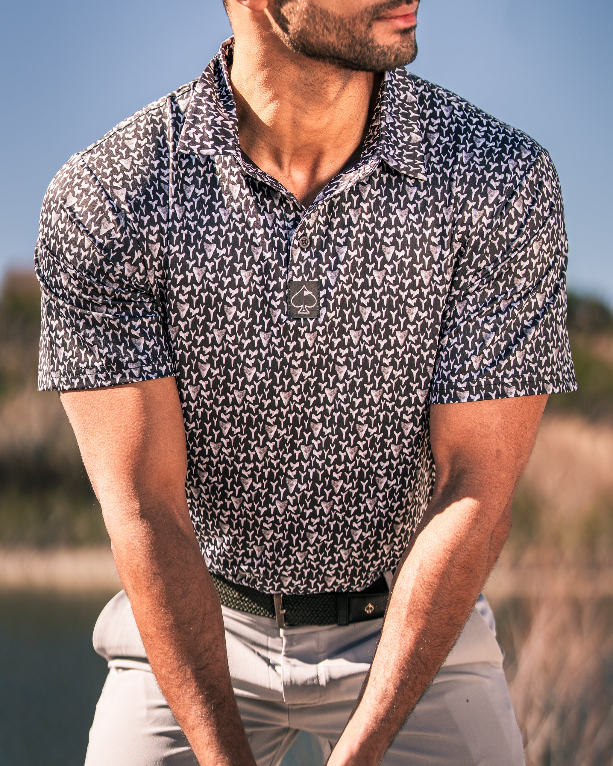 Men's Shark Tooth golf shirt featuring a bold pattern, perfect for golfers seeking stylish performance on the course.