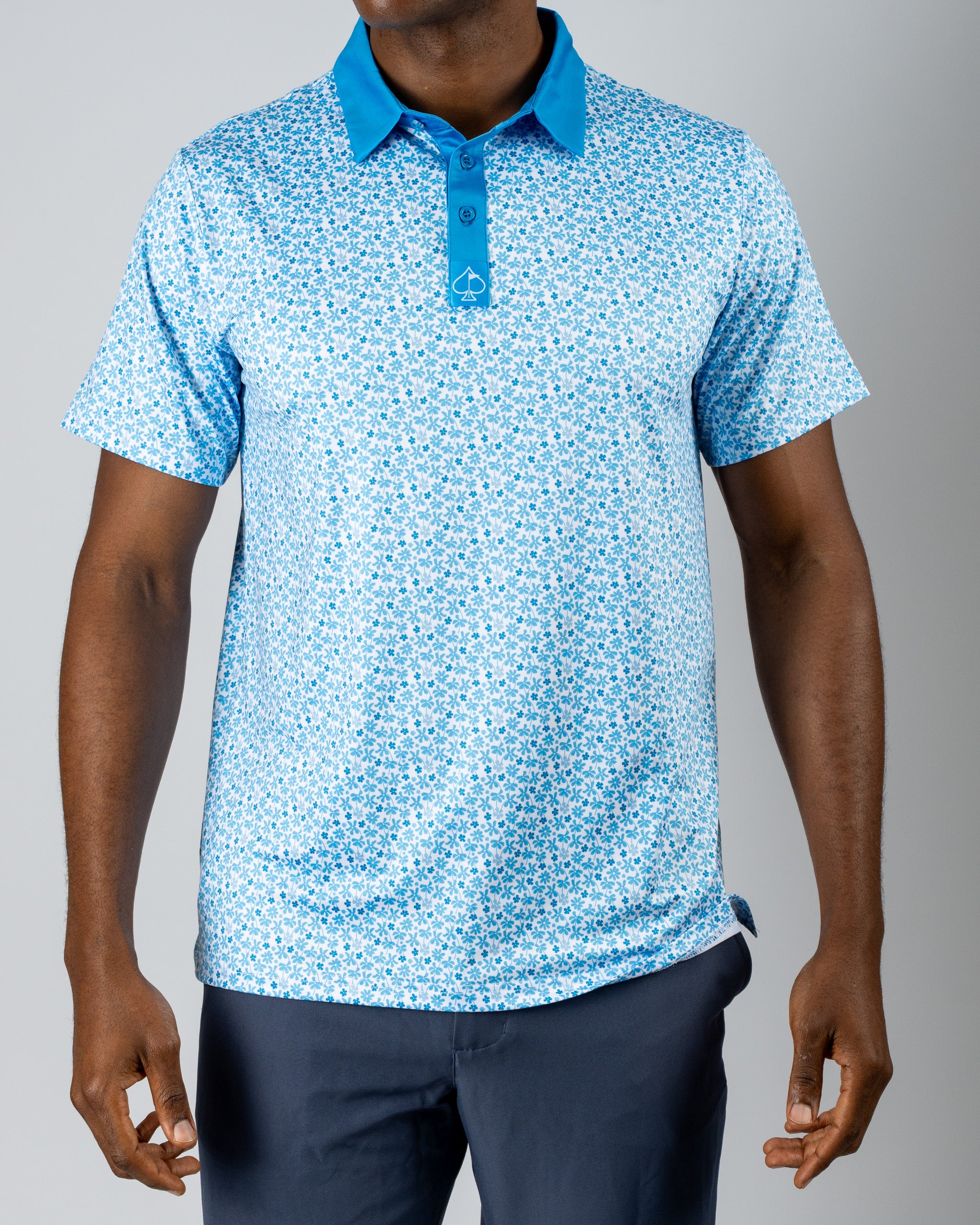Men's short-sleeve golf polo in light blue with a floral pattern and contrasting collar, perfect for stylish play on the course.