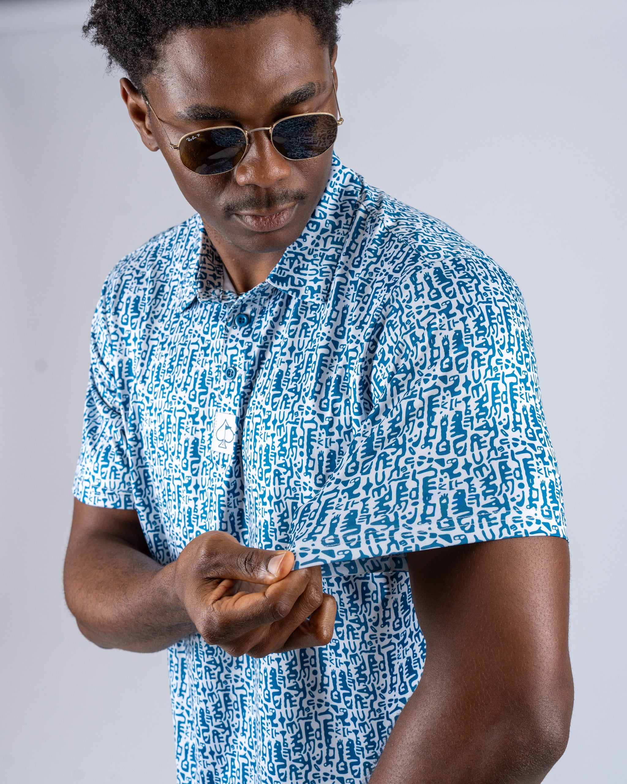Stylish golfer wearing a blue Maze Craze shirt with a unique pattern, showcasing its vibrant design and modern fit.