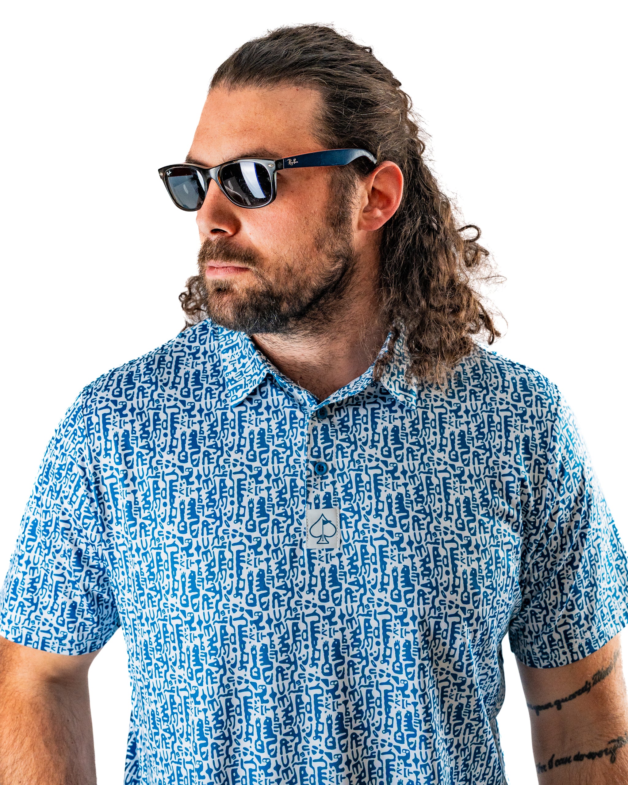 Men's Maze Craze golf shirt featuring a bold blue pattern, paired with stylish sunglasses for a standout look on the course.
