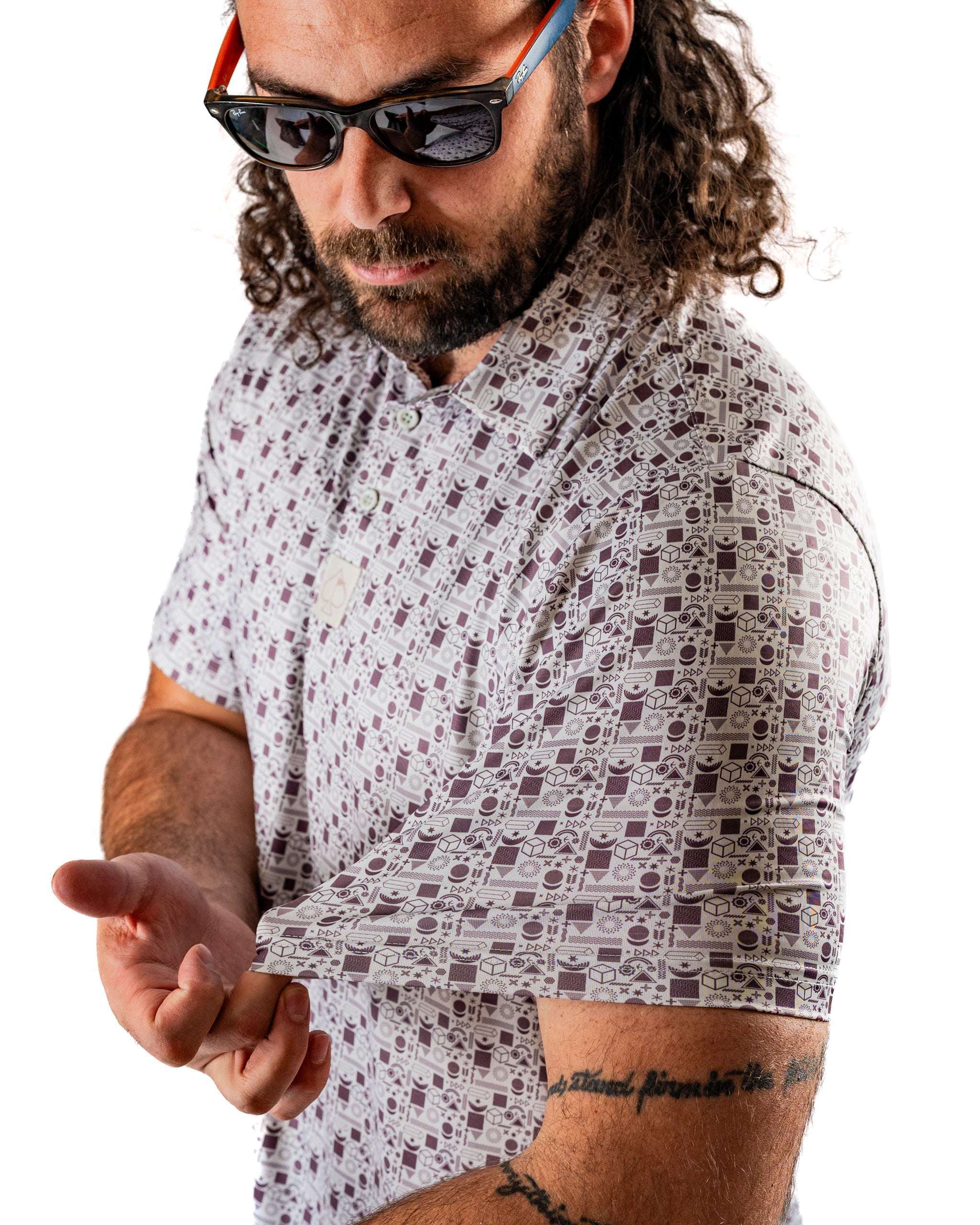 Man wearing a retro-patterned golf shirt featuring vintage cameras, showcasing the unique design and style.