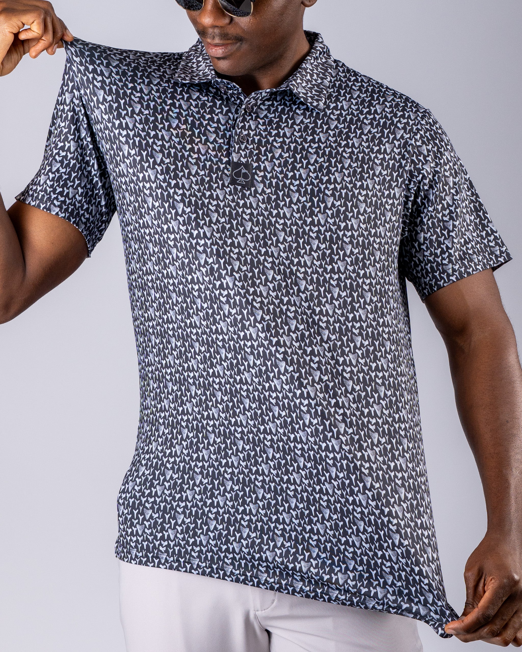 Men's golf polo featuring a shark tooth pattern in shades of blue and gray, designed for a stylish and bold look on the course.