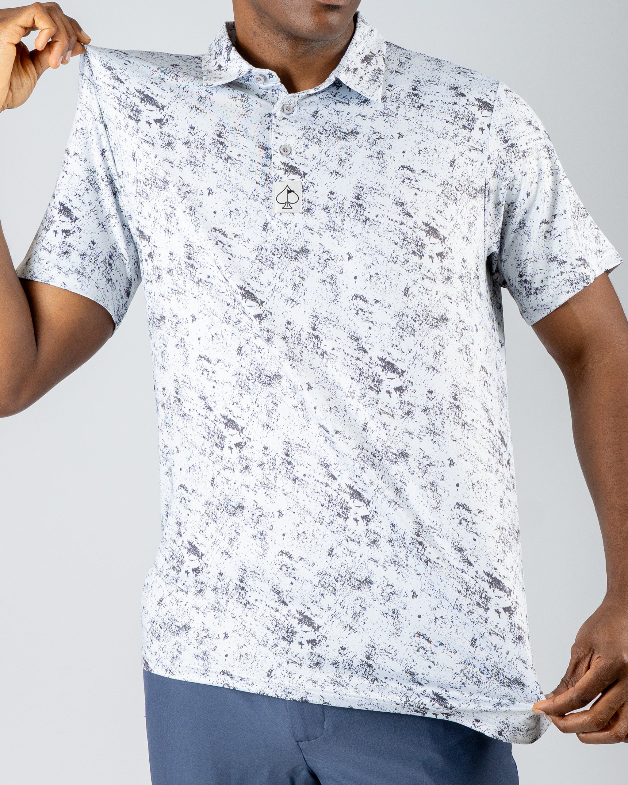 Men's short-sleeve golf polo in a white and gray abstract pattern, featuring a subtle logo on the chest.
