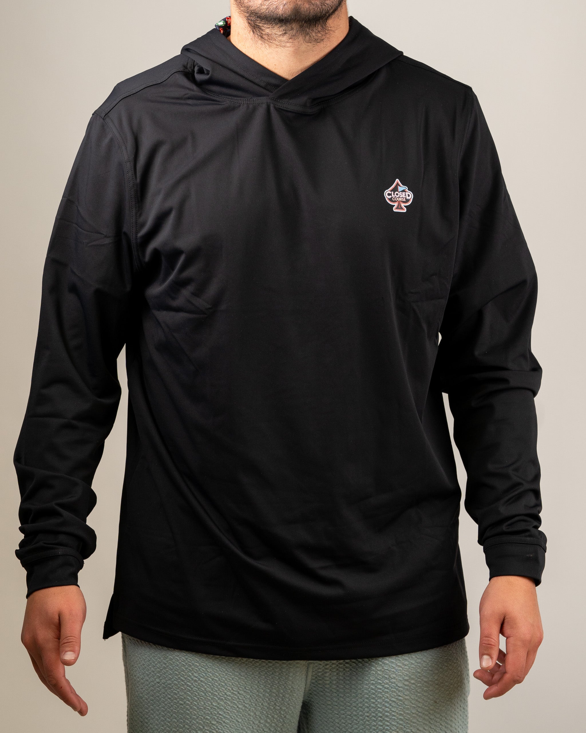 Men's black performance golf hoodie featuring a front logo, designed for comfort and style on the golf course.