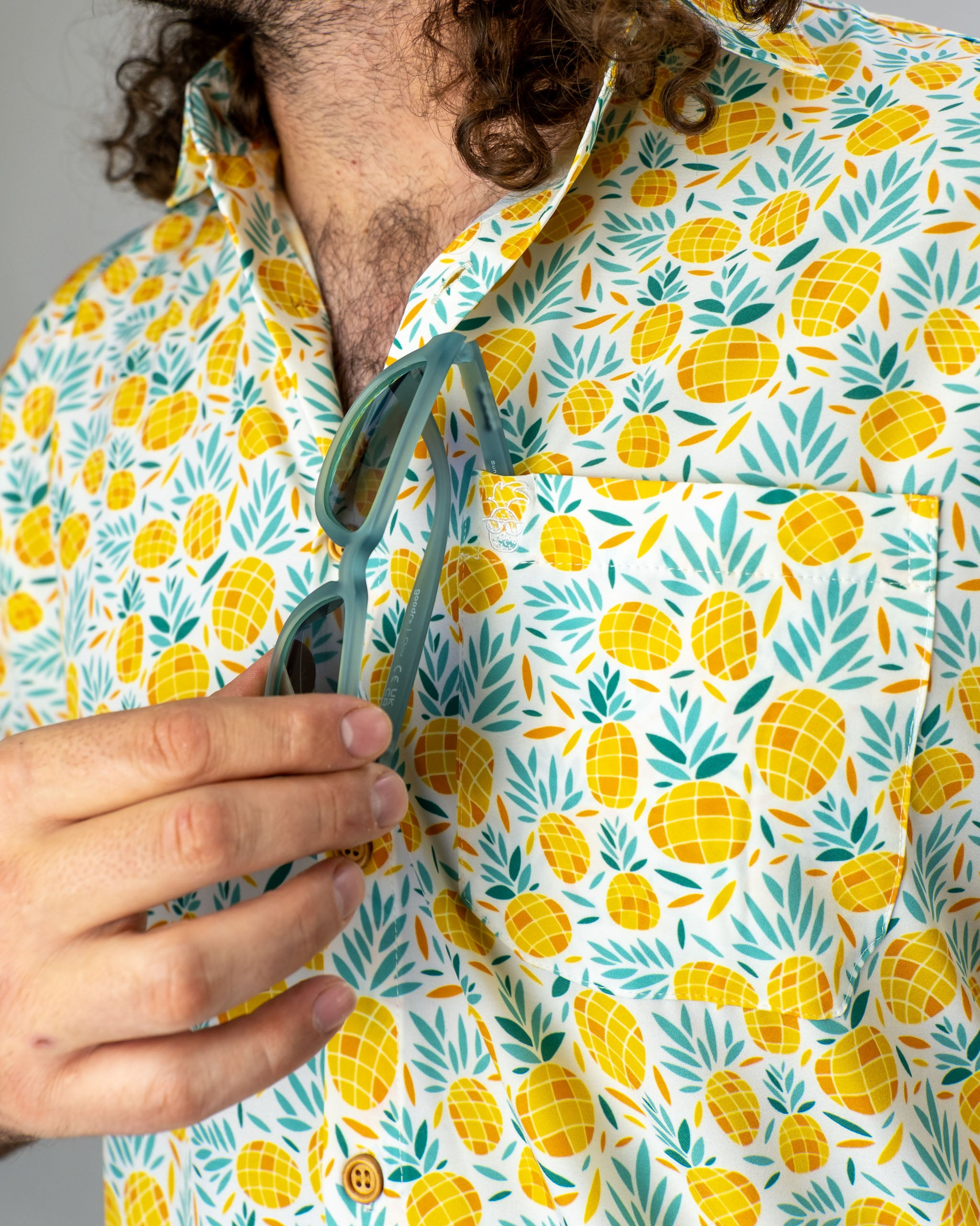 Bold pineapple-patterned shirt featuring vibrant colors, perfect for stylish golfers looking to stand out on the course.
