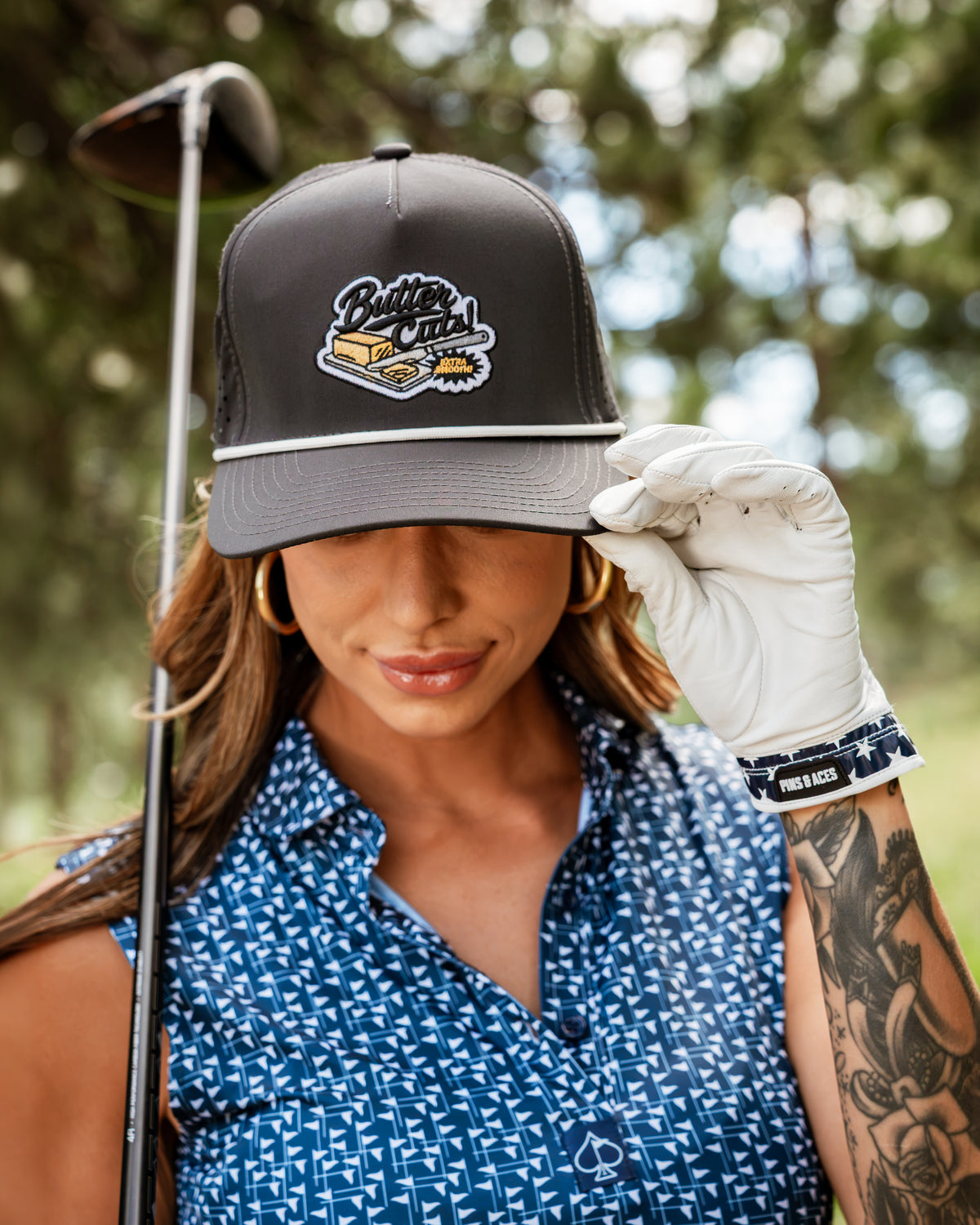 Navy and white women's golf cap featuring a flag stick design, perfect for stylish golfers on the course.