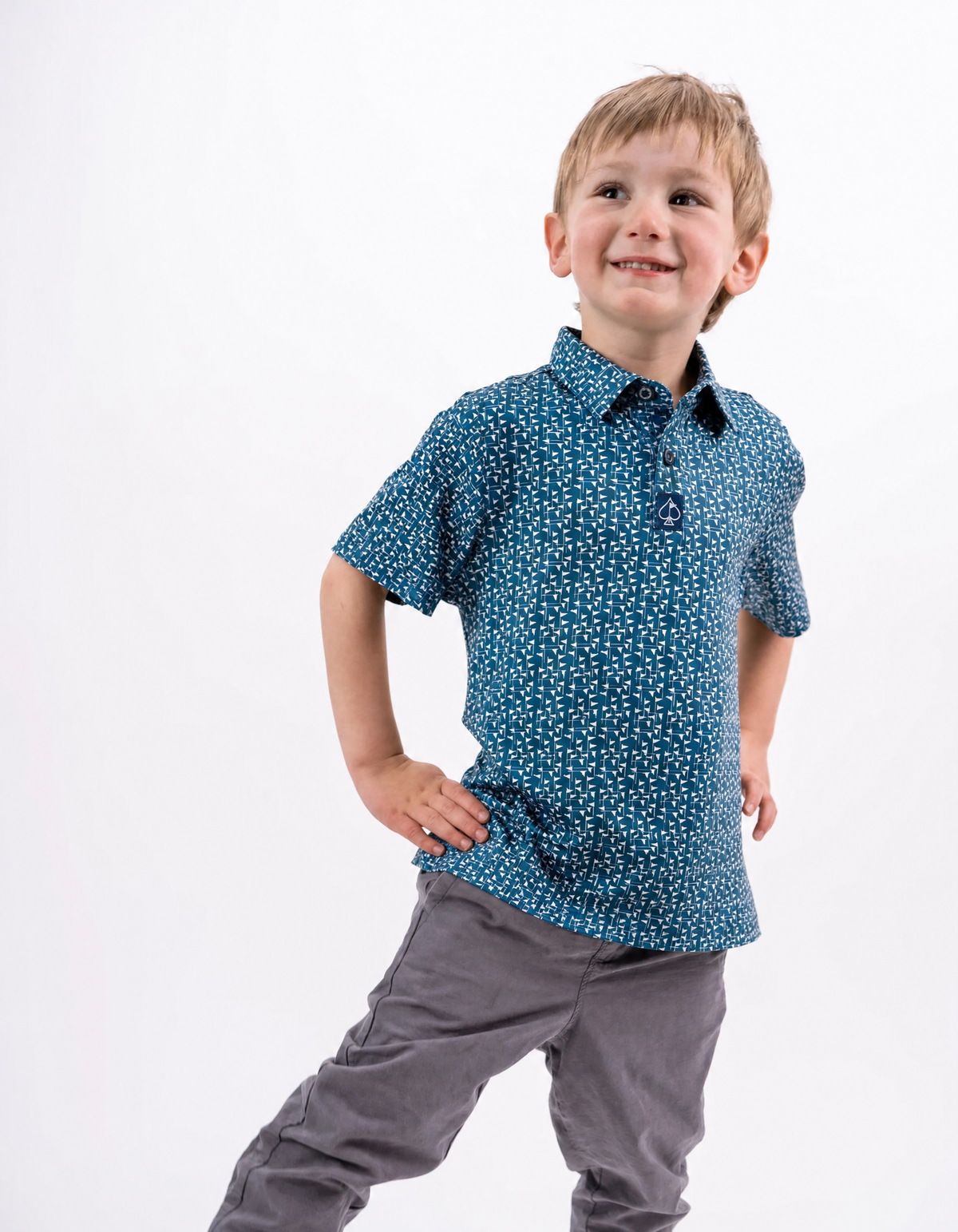 Youth Flag Stick shirt in navy and white features a playful pattern, perfect for young golfers looking to stand out.