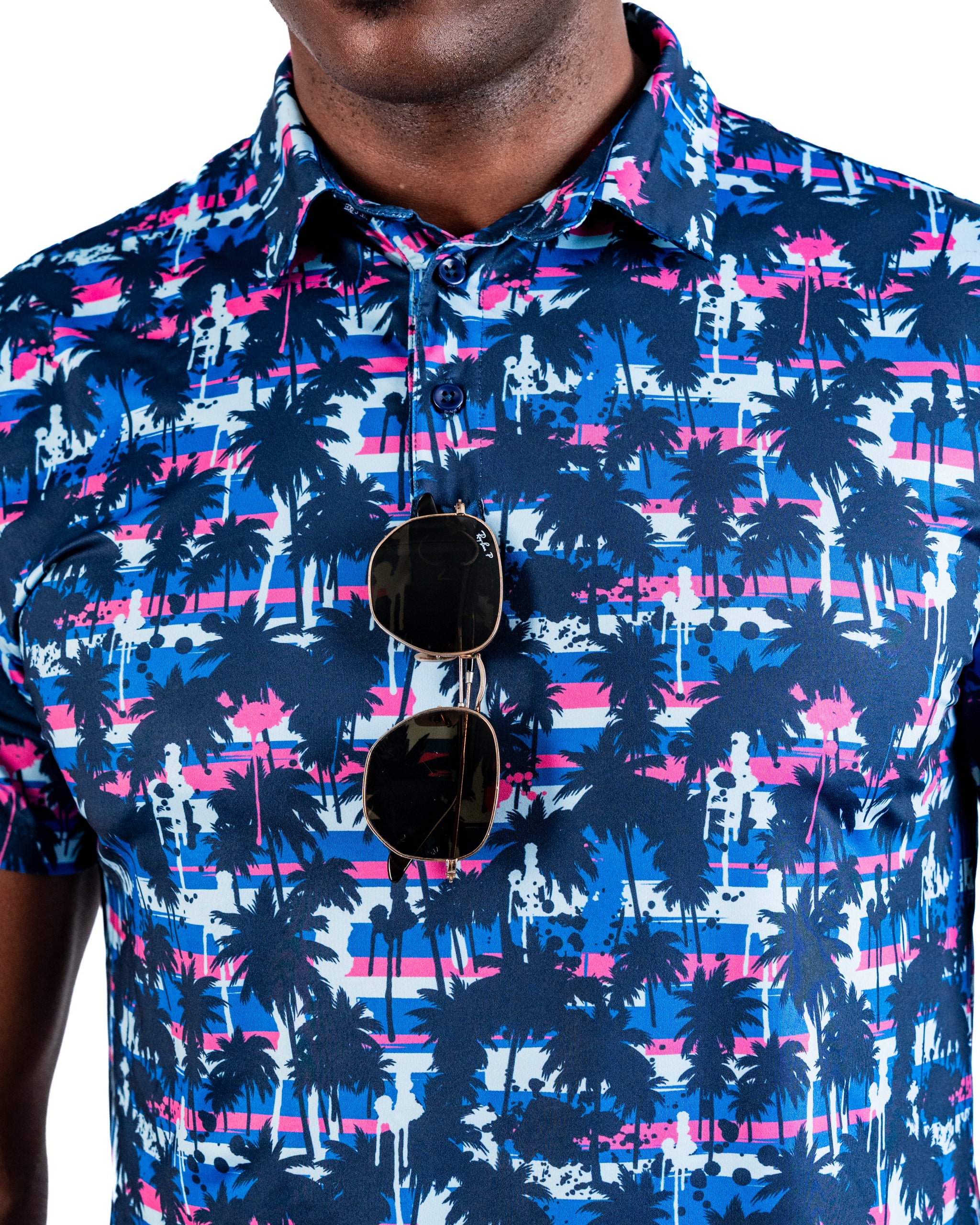 Bold golf shirt featuring a vibrant palm tree pattern in blue, pink, and white, perfect for stylish golfers.