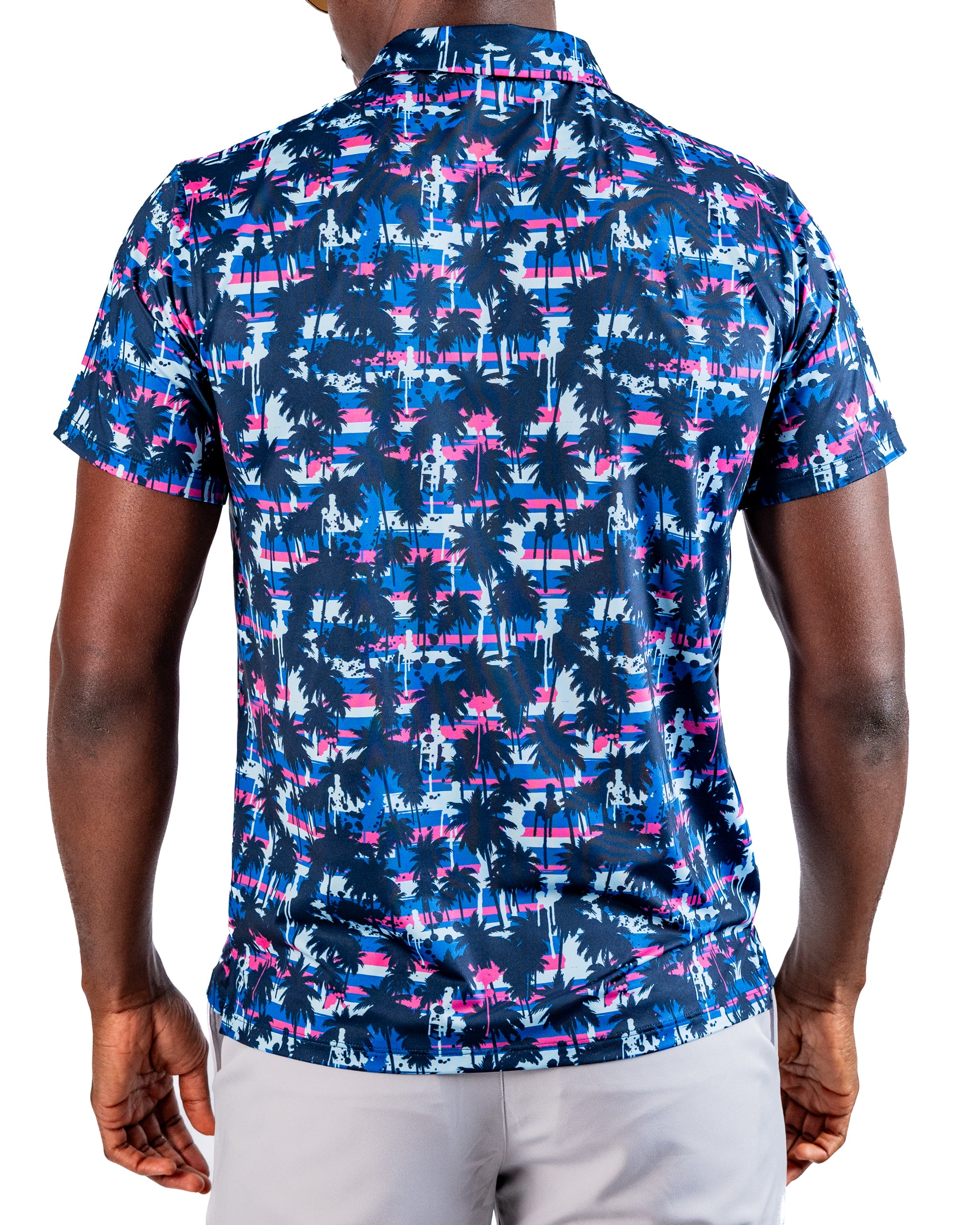 Men's golf shirt featuring a vibrant palm tree pattern in blue, pink, and white, designed for a bold on-course look.