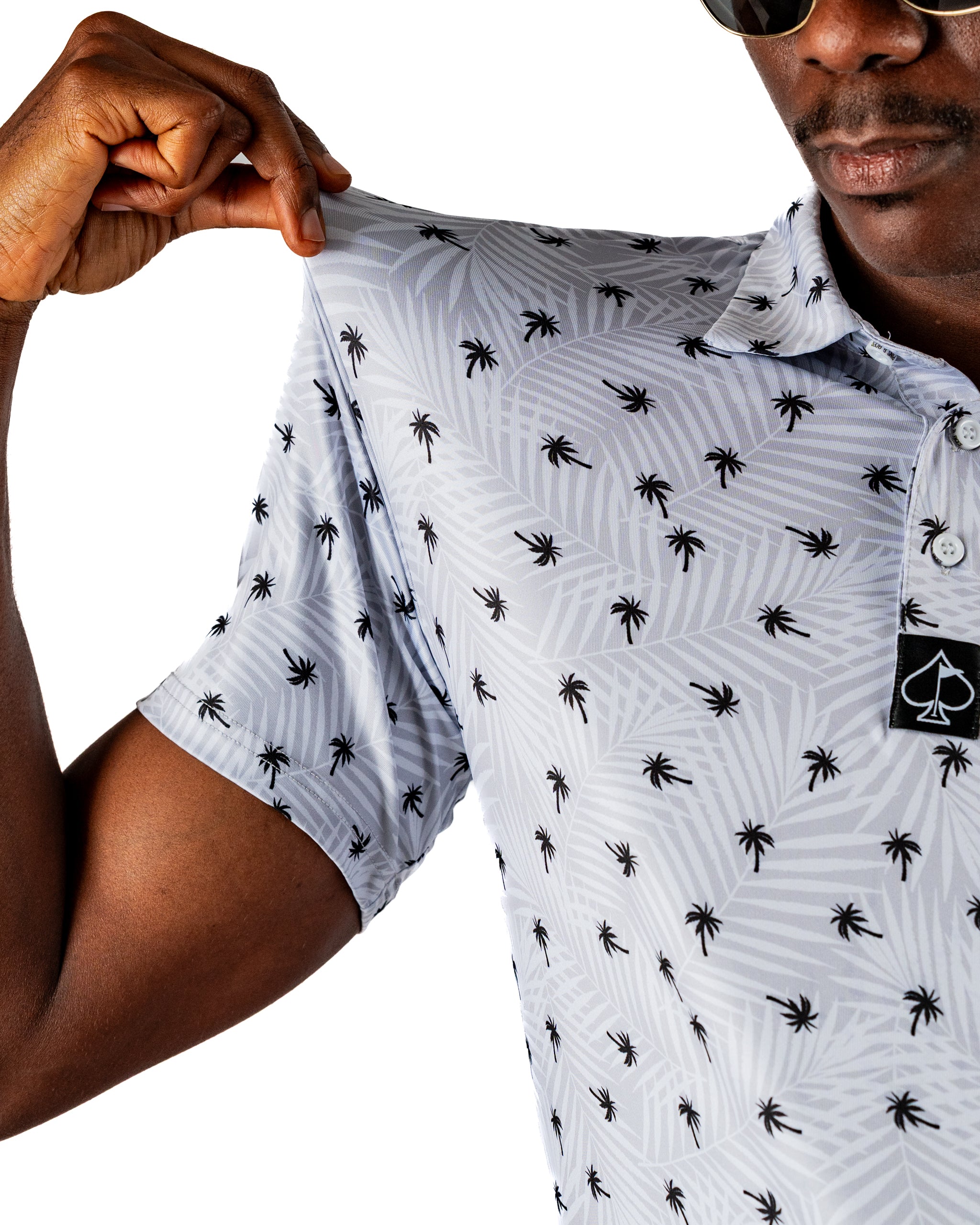 Men's golf polo shirt featuring a stylish palm tree pattern, perfect for a bold look on the course.