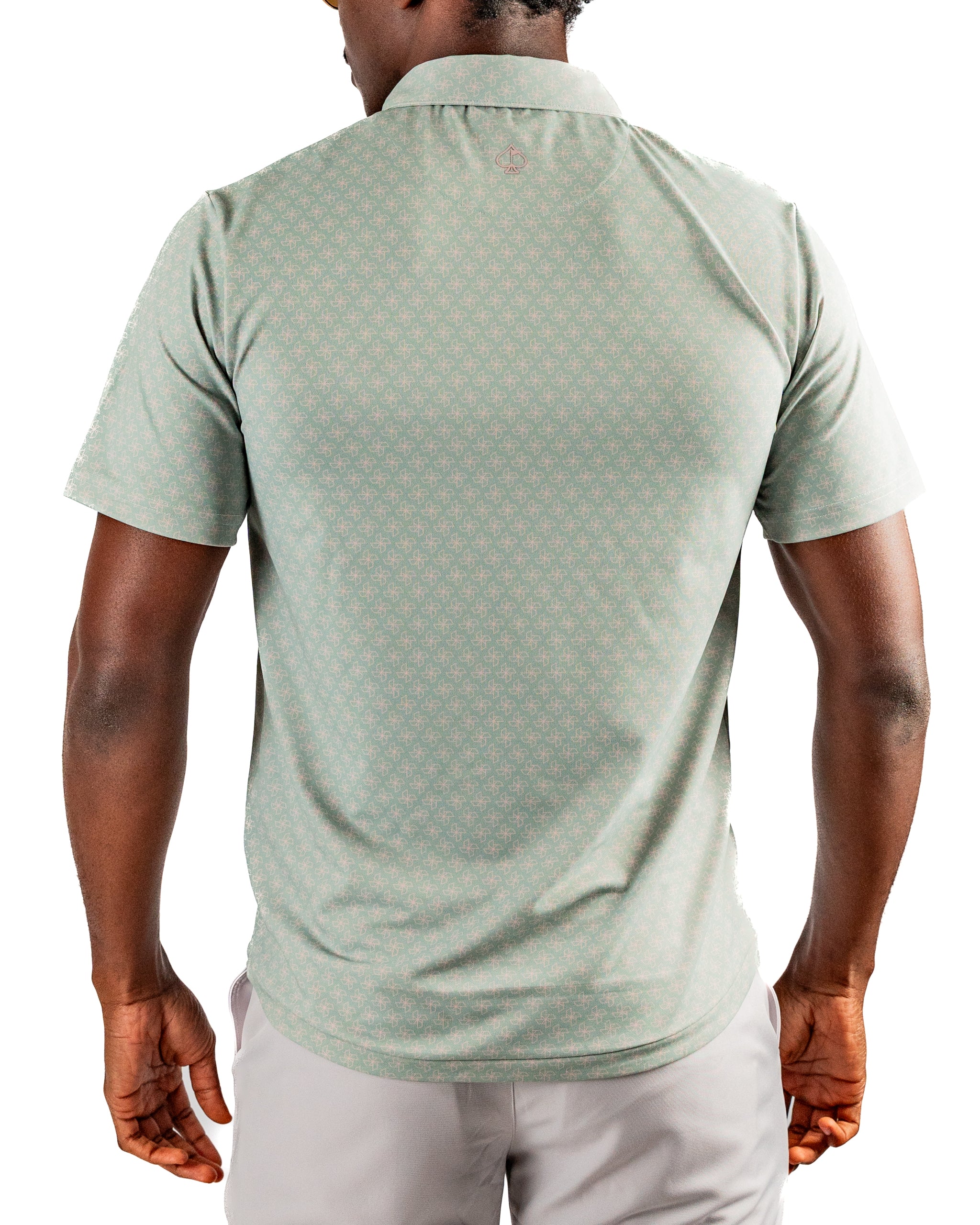 Men's short-sleeve golf shirt in a light green color with a subtle origami pattern, featuring a classic polo collar and relaxed fit.