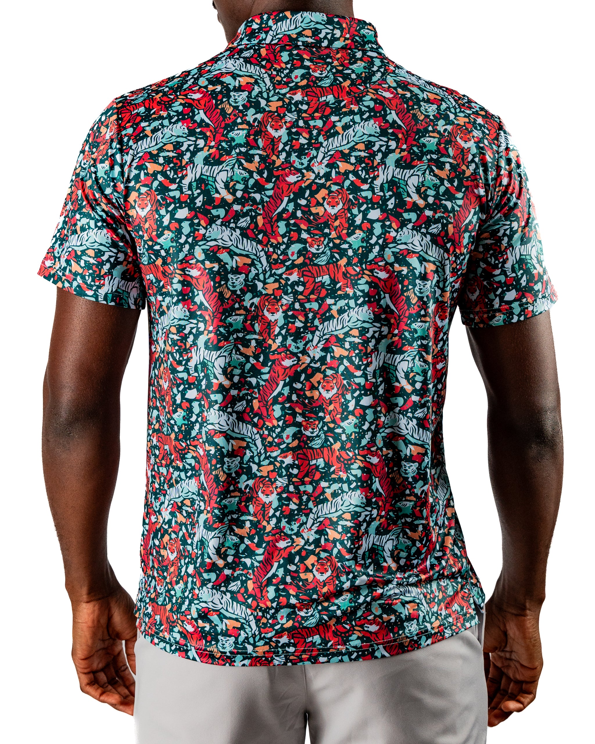 Bold golf shirt featuring a vibrant teal pattern with tigers and floral elements, designed for standout style on the course.