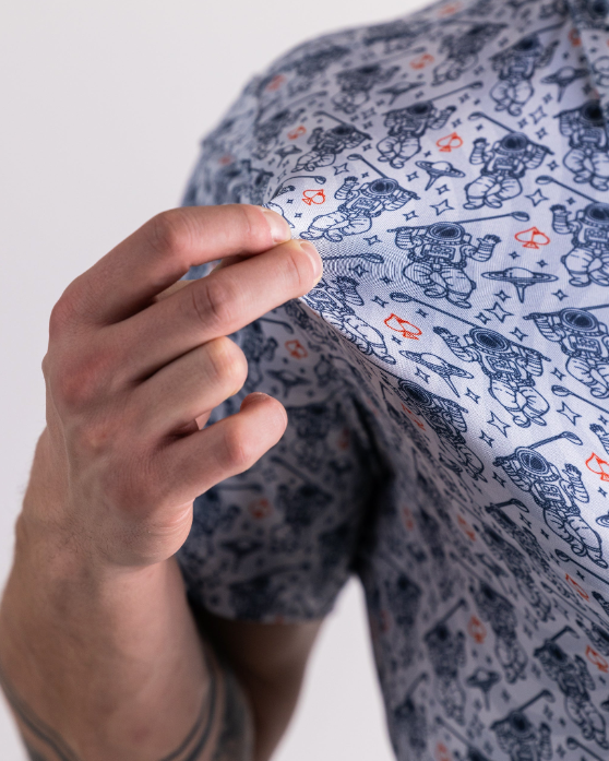 Gray NASA Space Walker shirt featuring playful astronaut designs, perfect for golfers seeking a unique style on the course.