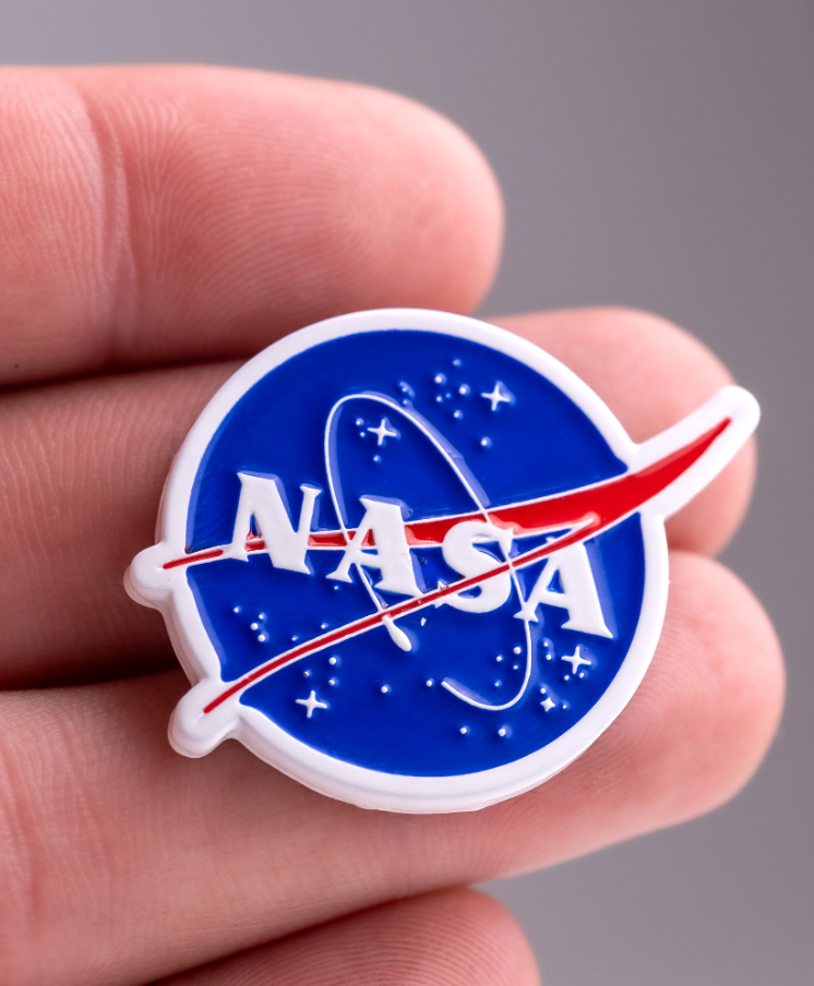 NASA "Meatball" ball marker featuring the iconic logo in blue and red, perfect for golf enthusiasts and space fans.