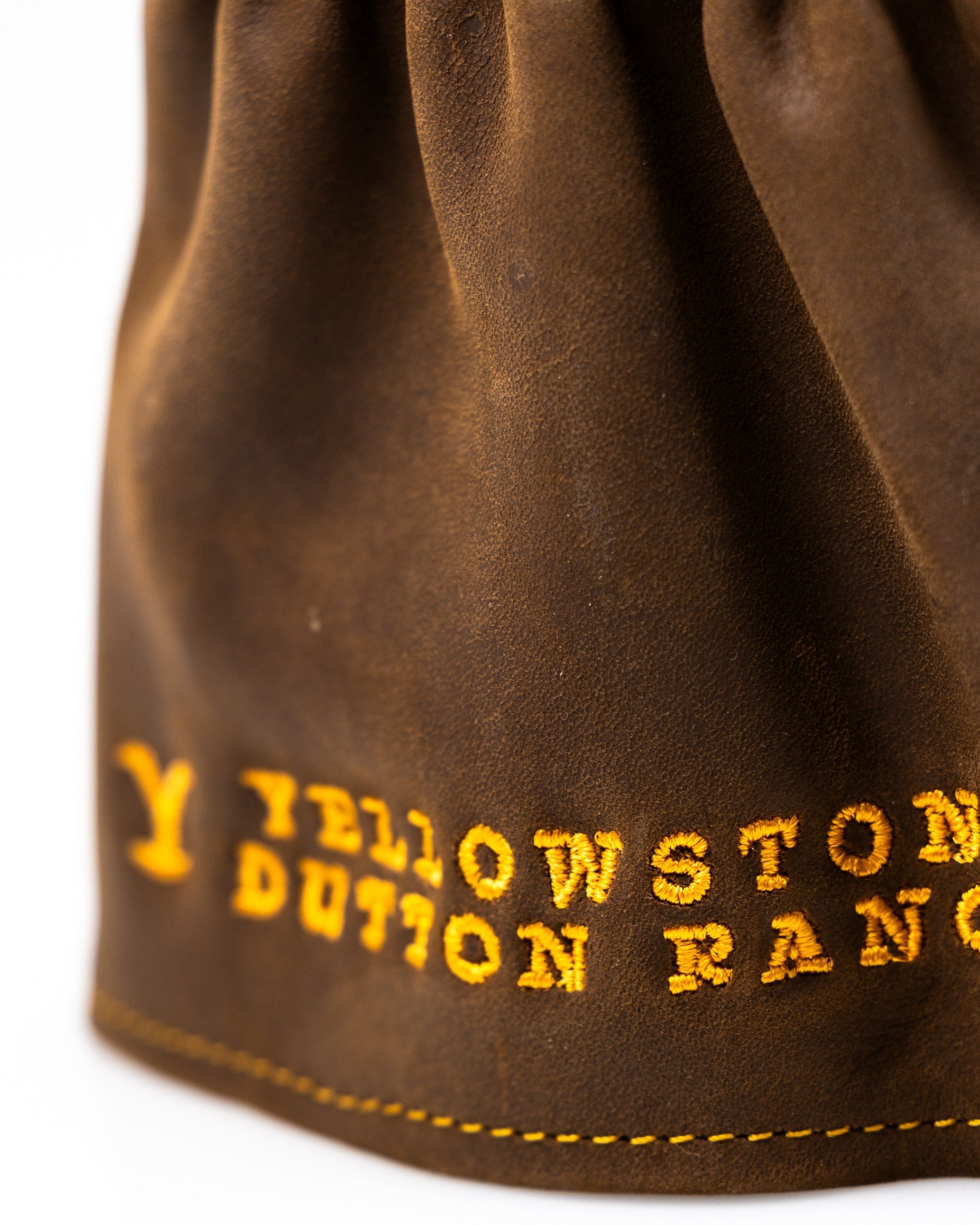 Brown leather driver cover featuring "Yellowstone Dutton Ranch" in bold yellow stitching, perfect for stylish golfers.