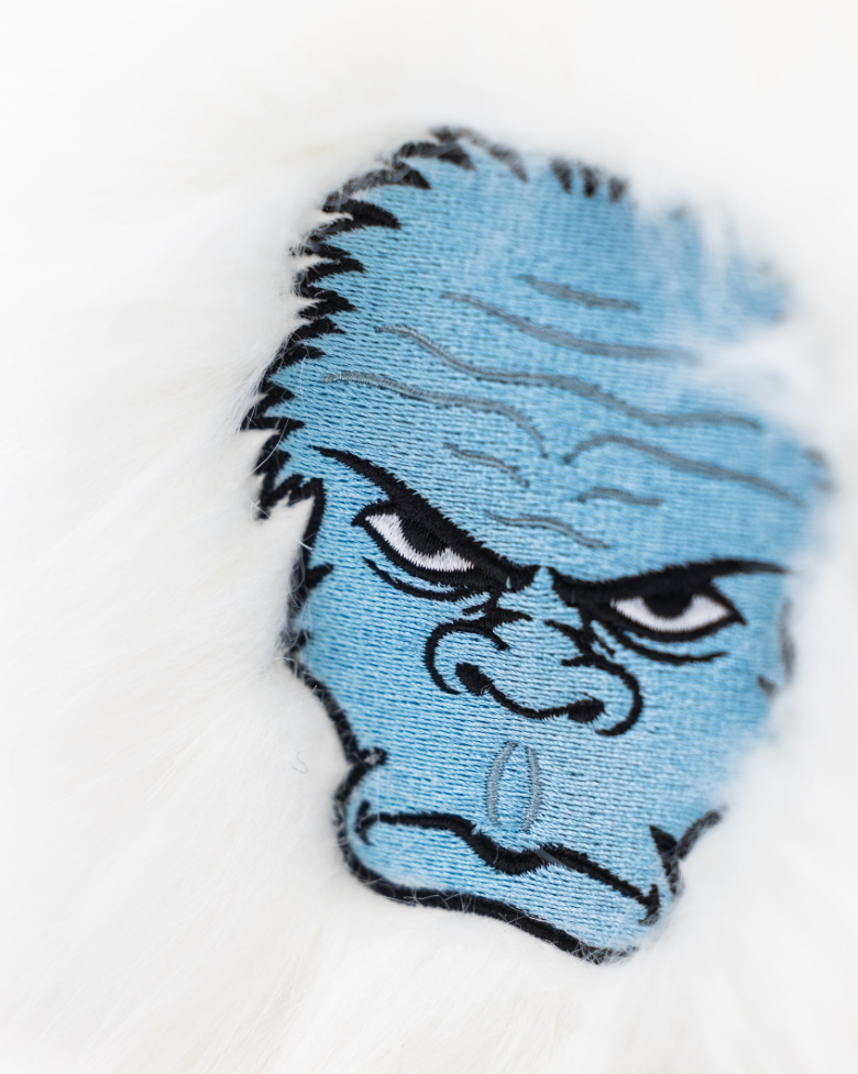 Yeti mallet cover featuring a blue yeti face design on a fluffy white background, perfect for golf enthusiasts.