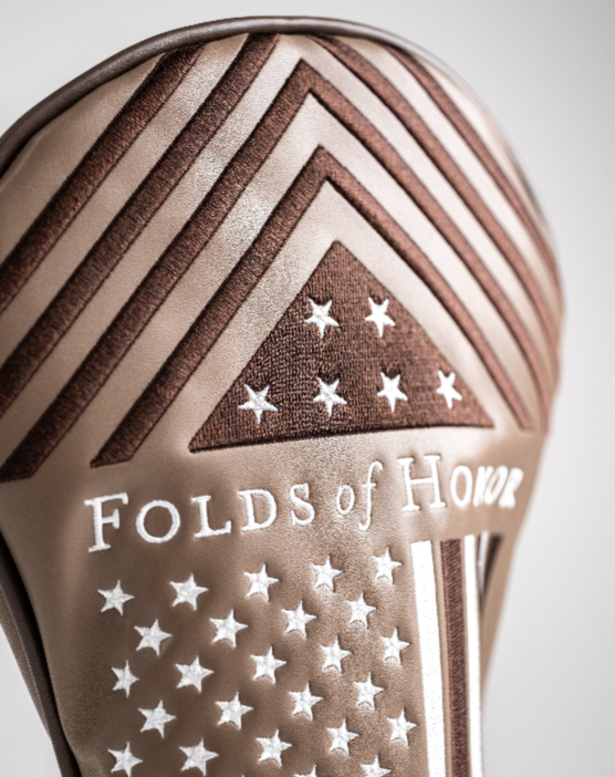 Folds of Honor 2.0 driver cover featuring a patriotic design with stars and stripes, showcasing a commitment to honor.