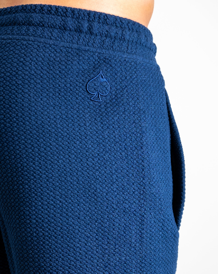 Navy waffle knit shorts featuring a subtle spade logo, designed for comfort and style on and off the golf course.