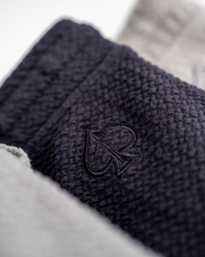 Close-up of Player Preferred Waffleknit Shorts in Obsidian, showcasing textured fabric and subtle logo detail.