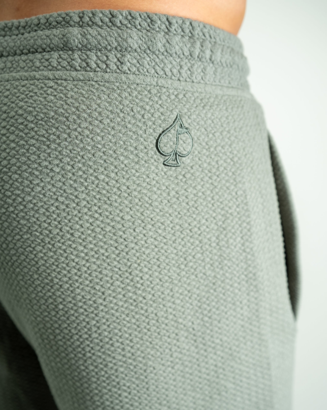 Sage green waffle knit shorts featuring a subtle spade logo, designed for comfort and style on the golf course.