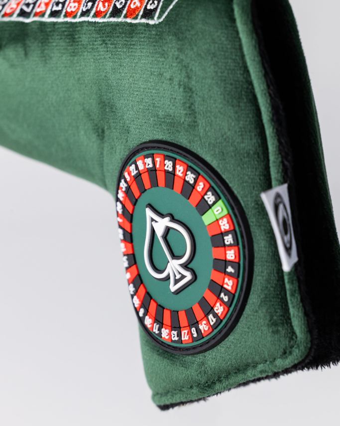 Roulette blade putter cover featuring a green felt design and a vibrant roulette wheel graphic for a bold golf style.
