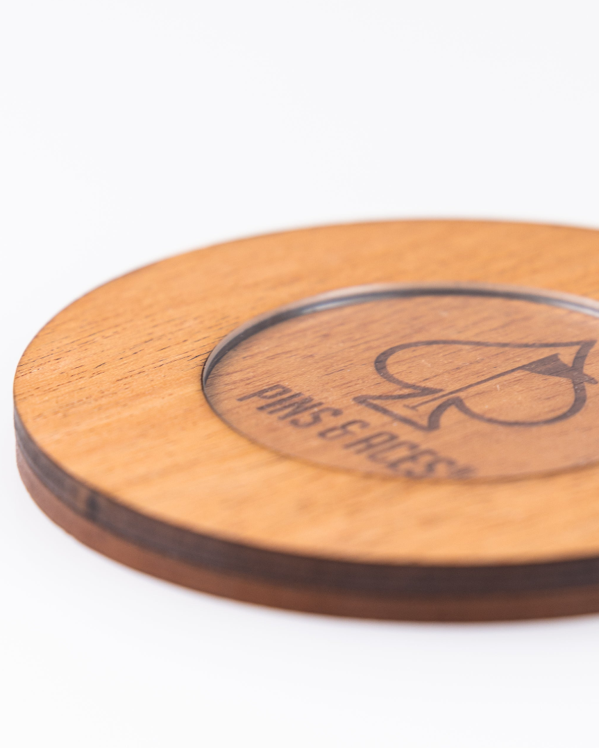 Wooden coaster set featuring a sleek design with the Pins & Aces logo, perfect for stylish golf enthusiasts.
