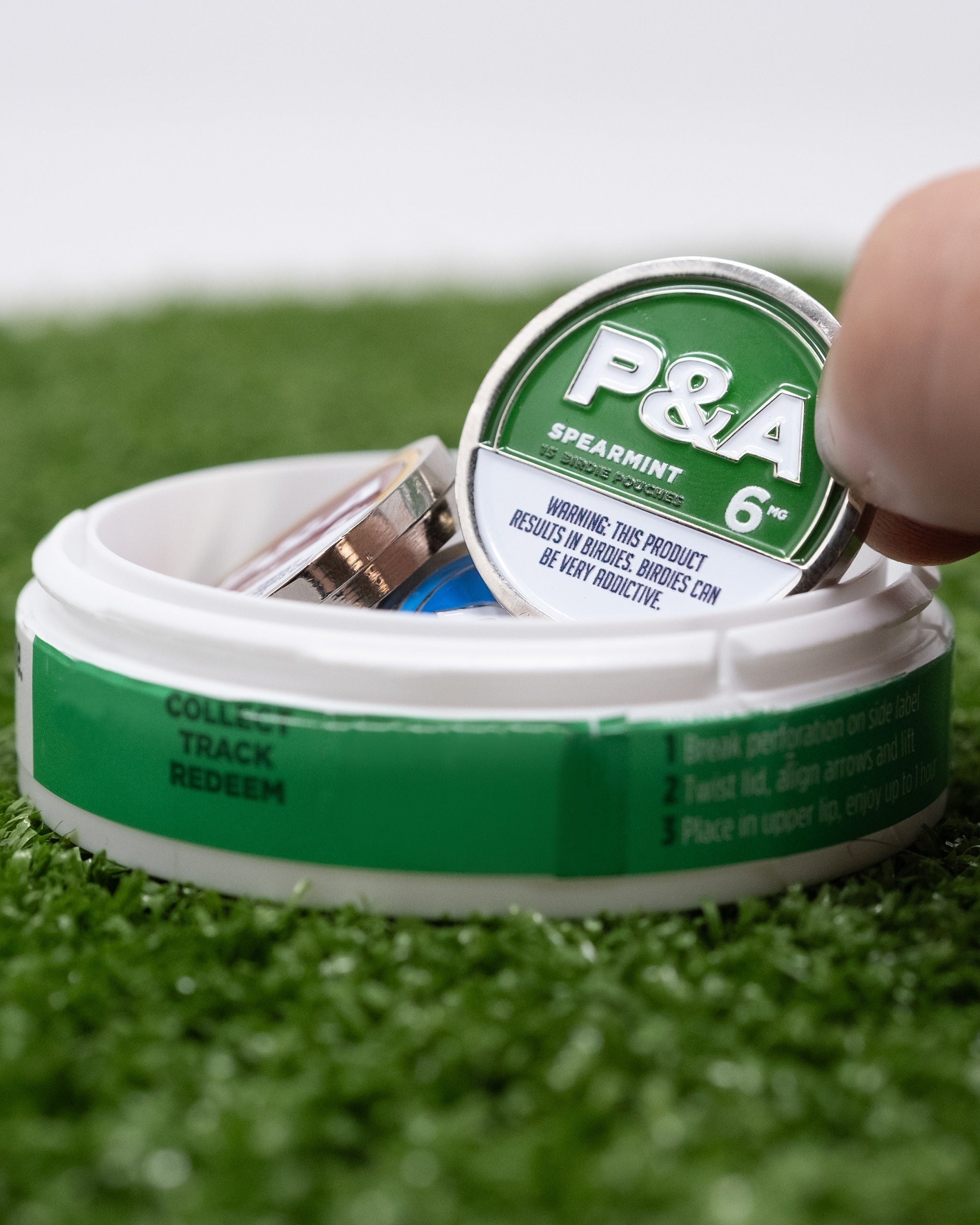 Spearmint ball marker from Pins and Aces, featuring a sleek design in a convenient container for golfers.