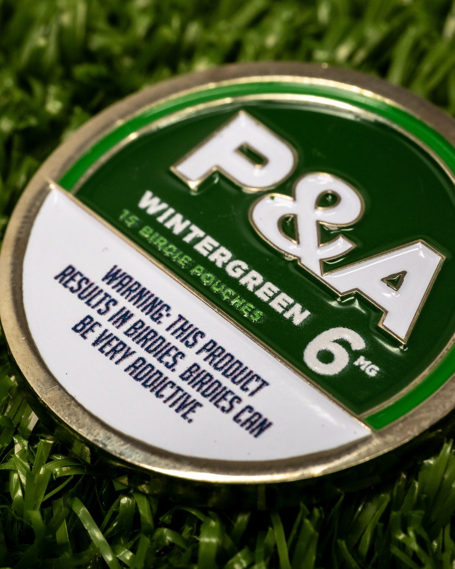 Wintergreen ball marker featuring bold P&A branding, designed for golfers seeking a unique accessory on the course.