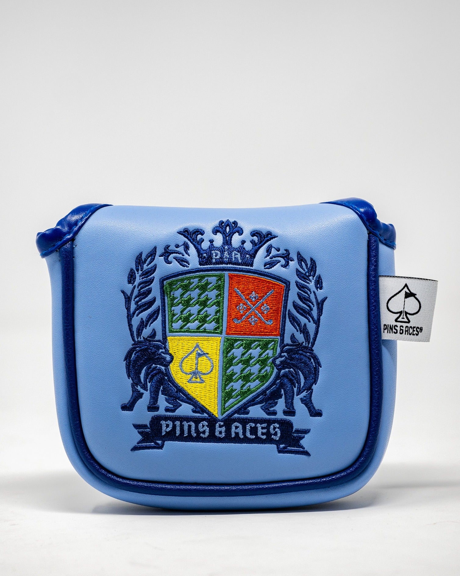 Blue mallet cover featuring a colorful coat of arms design with the Pins and Aces logo, perfect for stylish golfers.