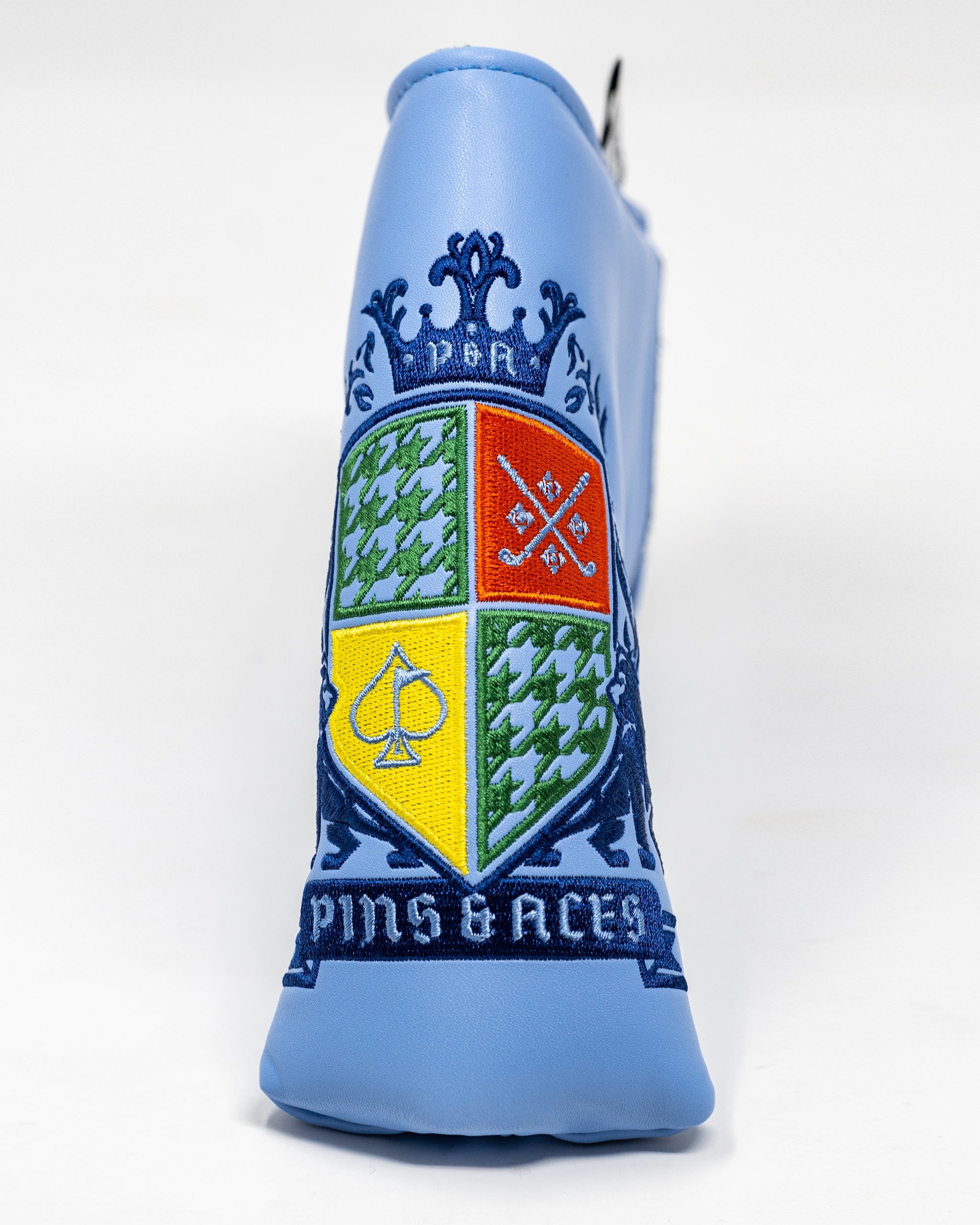 Blade putter cover featuring a vibrant coat of arms design with intricate embroidery and a bold blue background.