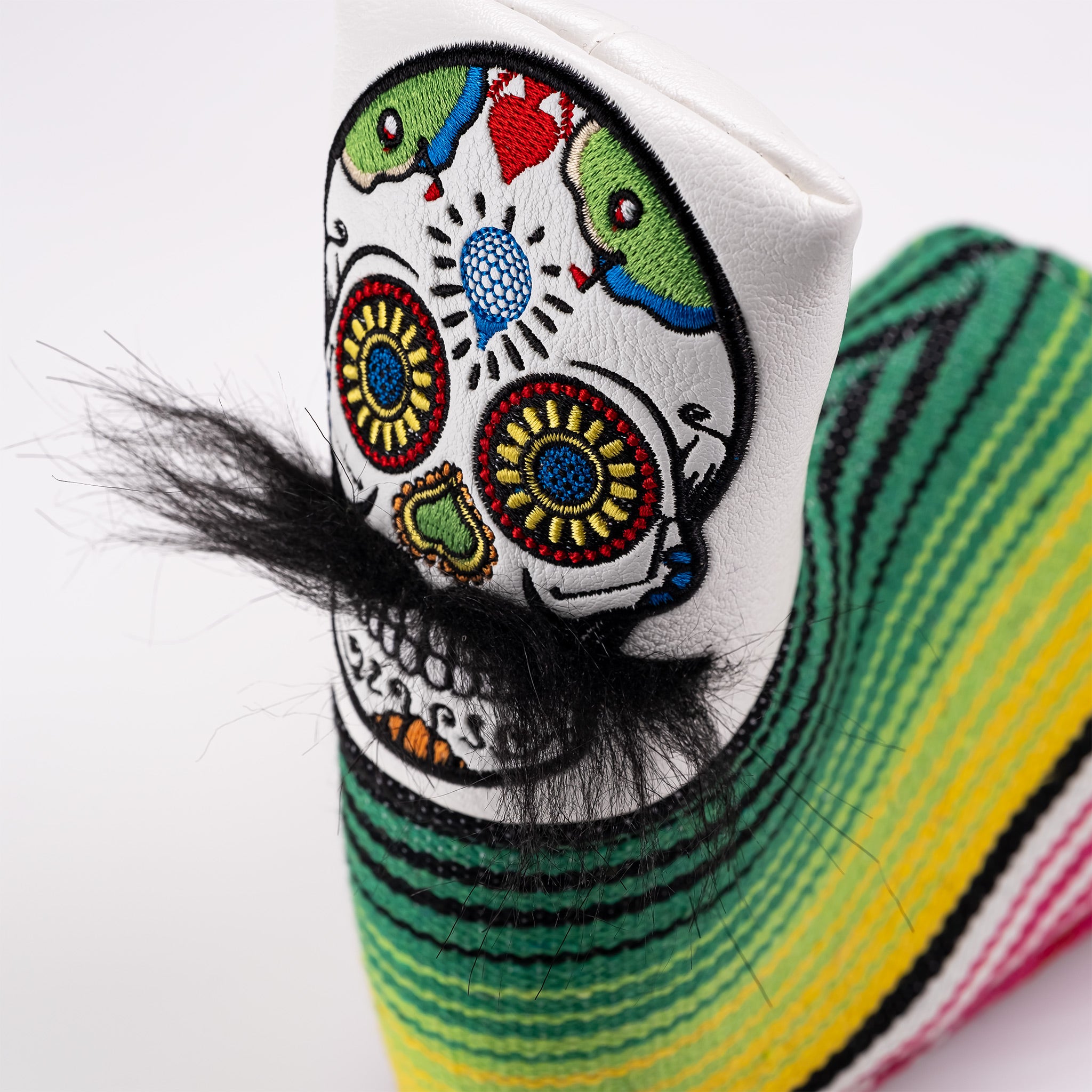 White blade putter cover featuring a colorful mustache sugar skull design with intricate embroidery and vibrant stripes.