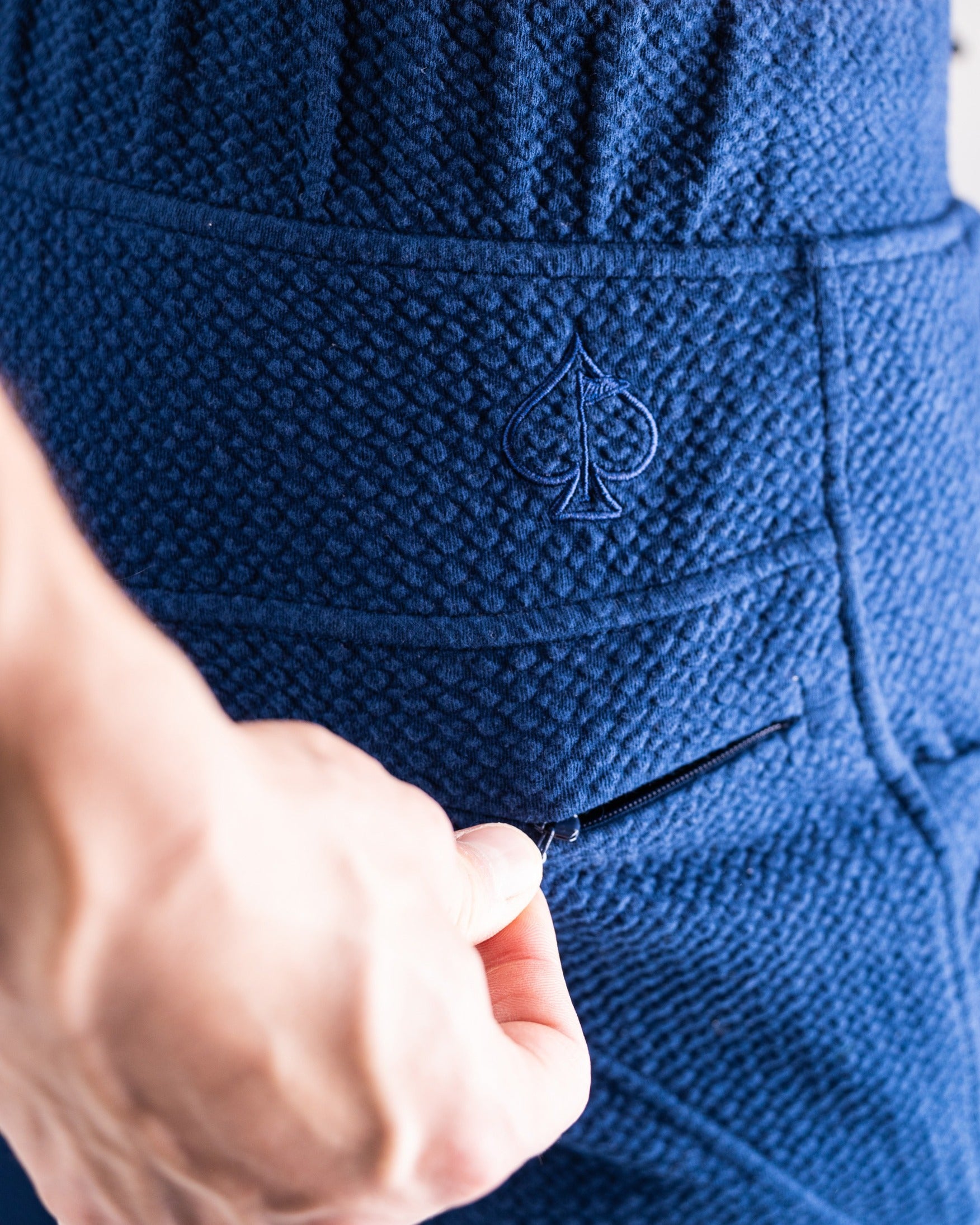 Close-up of the Player Preferred Waffleknit Jogger in Admiral, showcasing the textured fabric and spade logo on the pocket.