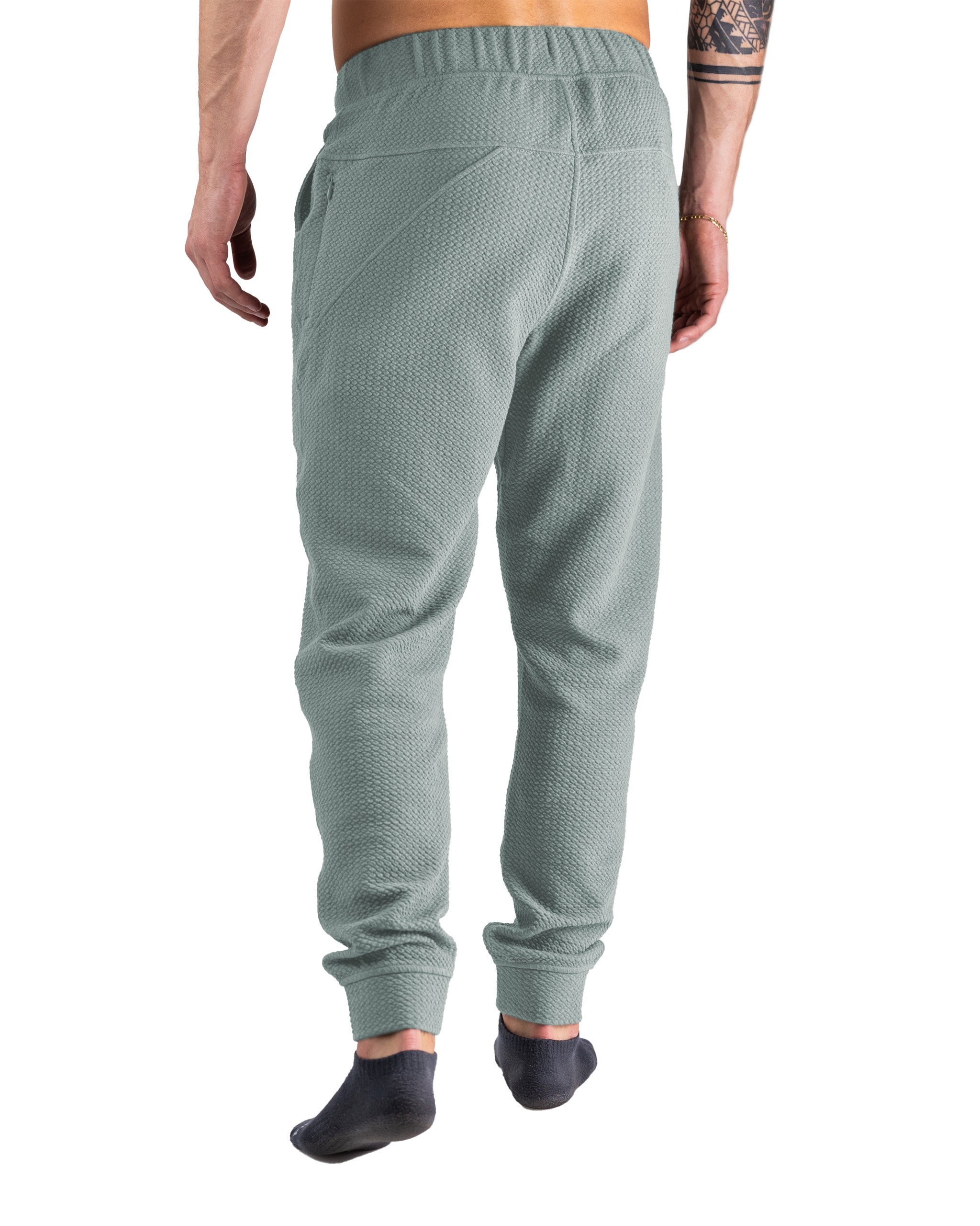 Men's sage green waffle-knit jogger with a relaxed fit, featuring side pockets and ribbed cuffs for comfort.