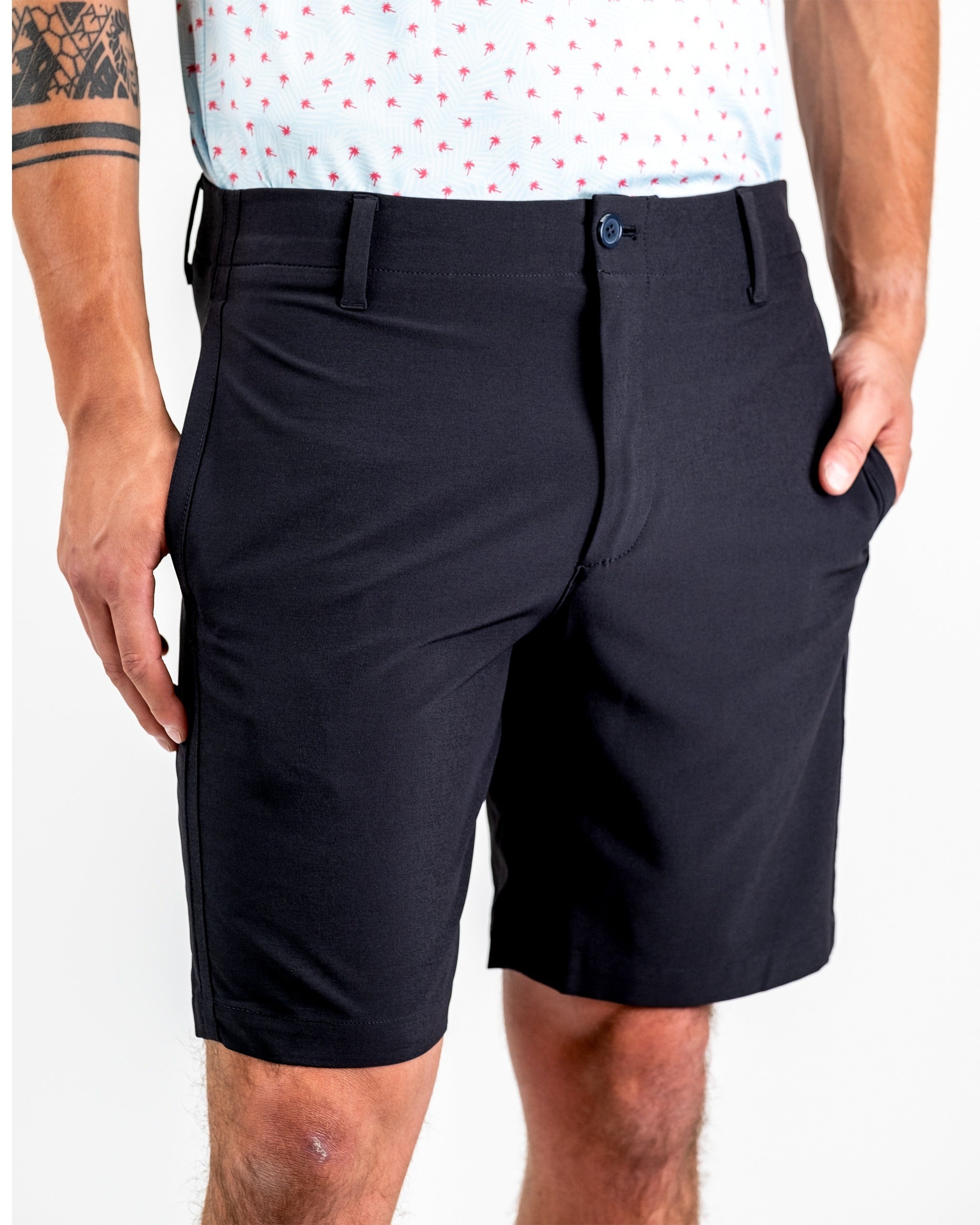 Men's black performance shorts featuring a sleek design, ideal for golf and active wear, with pockets for convenience.