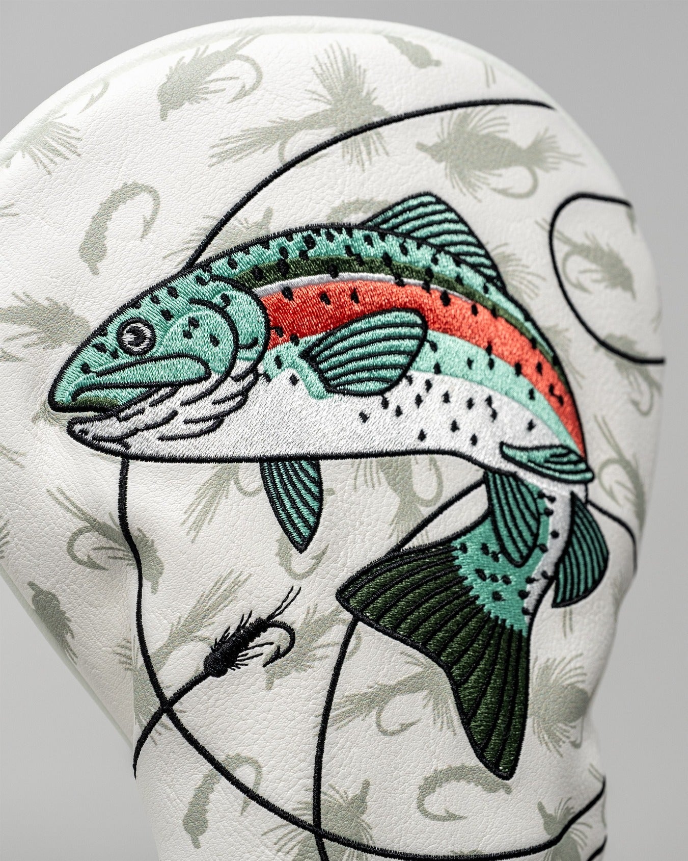 Trout driver cover featuring a detailed embroidered fish design on a textured white background, perfect for golf enthusiasts.