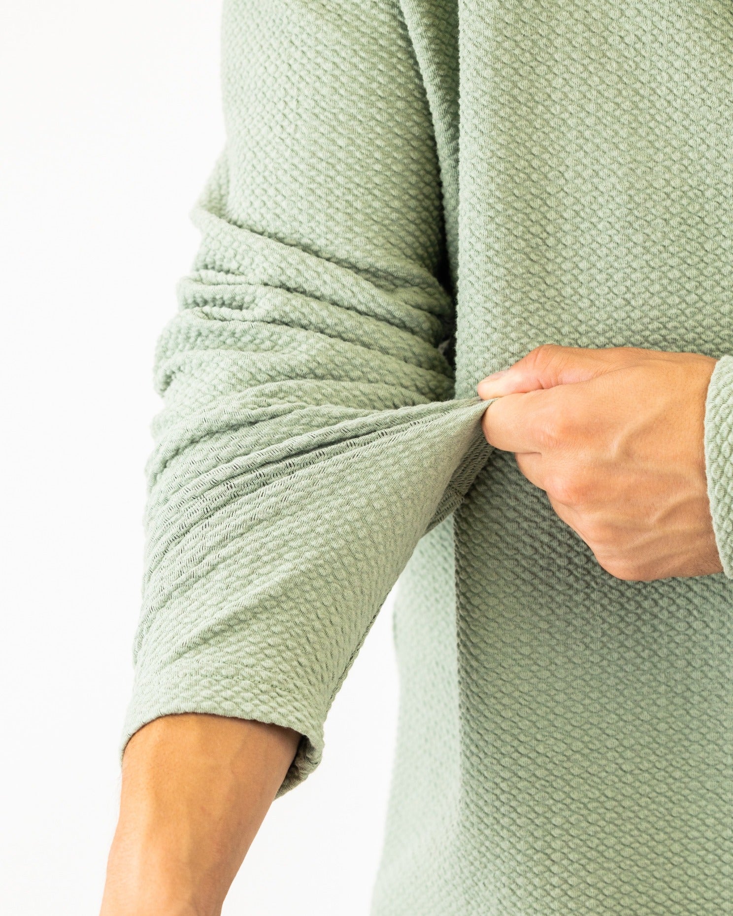 Olive green Player Preferred waffle knit pullover showcasing textured fabric and fitted sleeves for a stylish look.
