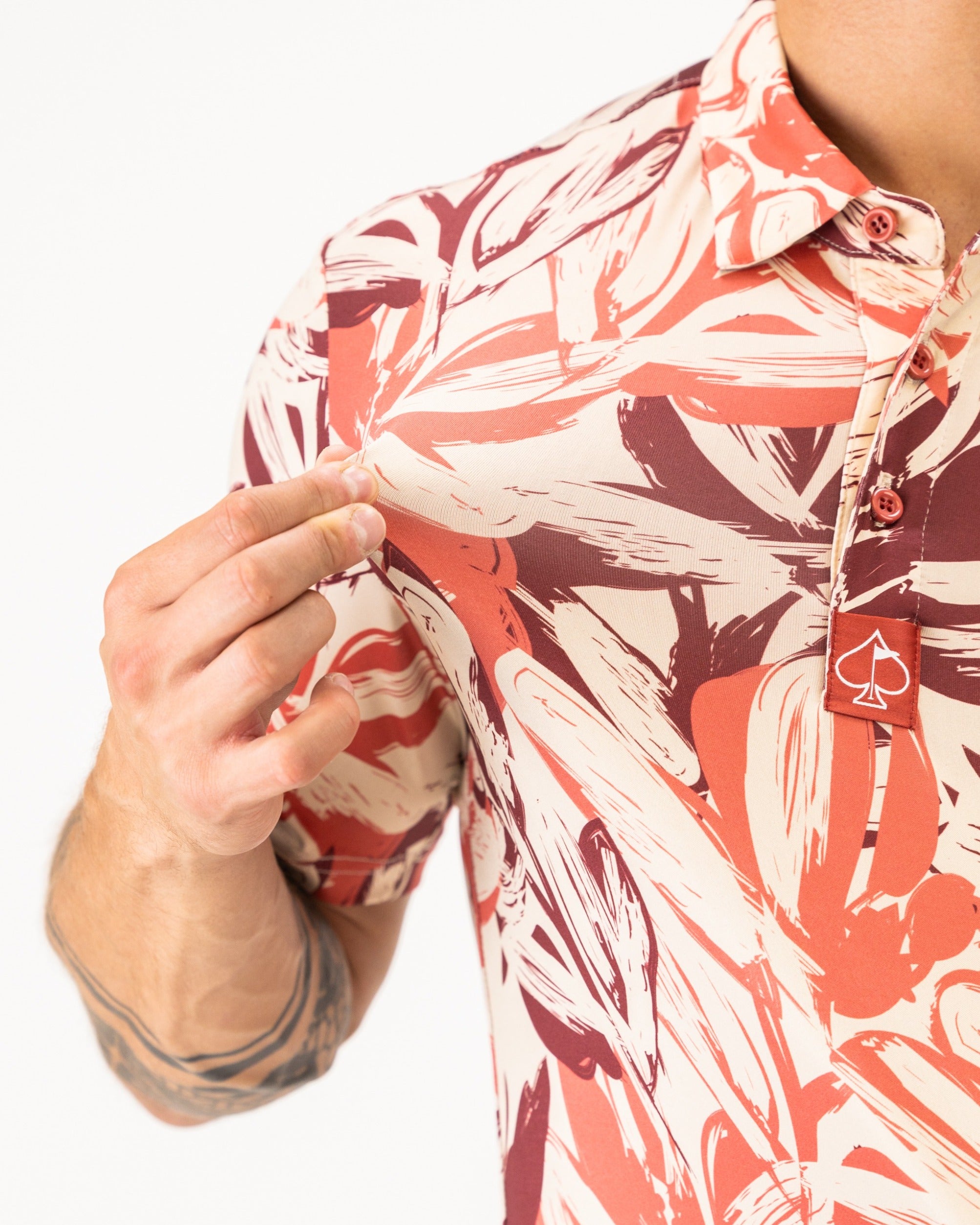 Men's brushed floral golf shirt featuring a vibrant, abstract design with bold colors, perfect for stylish play on the course.