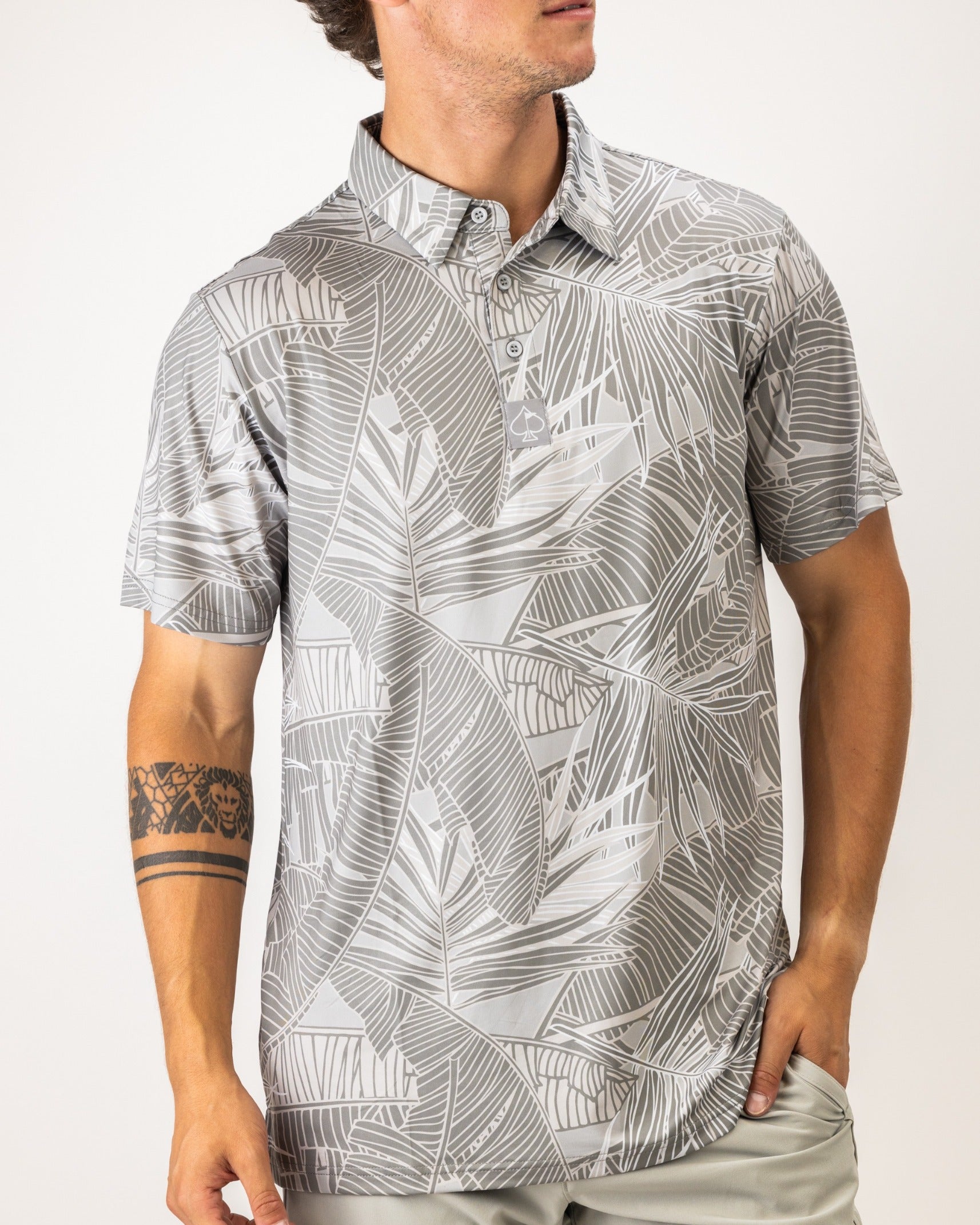 Men's golf polo shirt featuring a stylish gray palm leaf pattern, designed for a bold and unique look on the course.