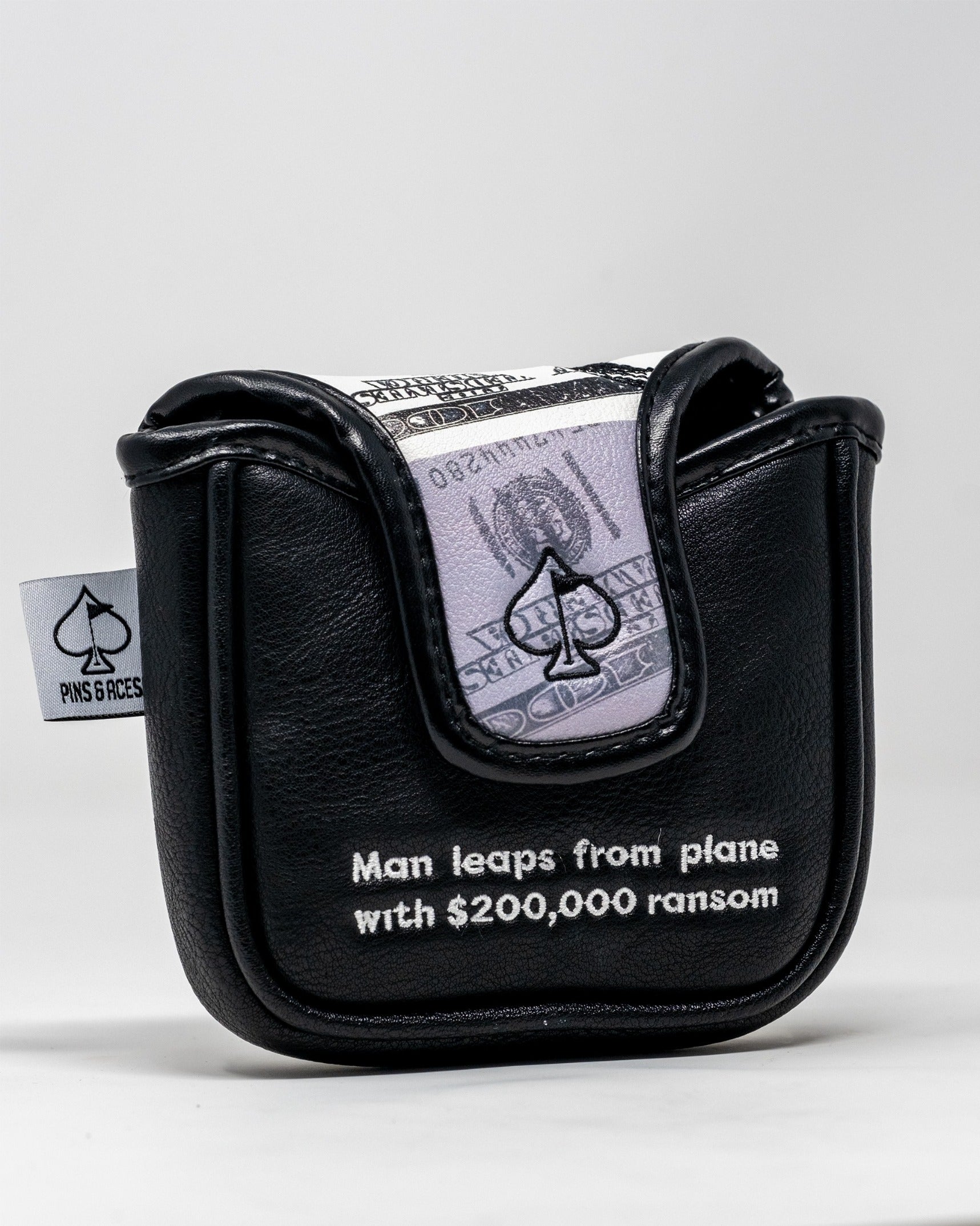 Bold black mallet putter cover featuring a design inspired by D.B. Cooper, with a money graphic and text.
