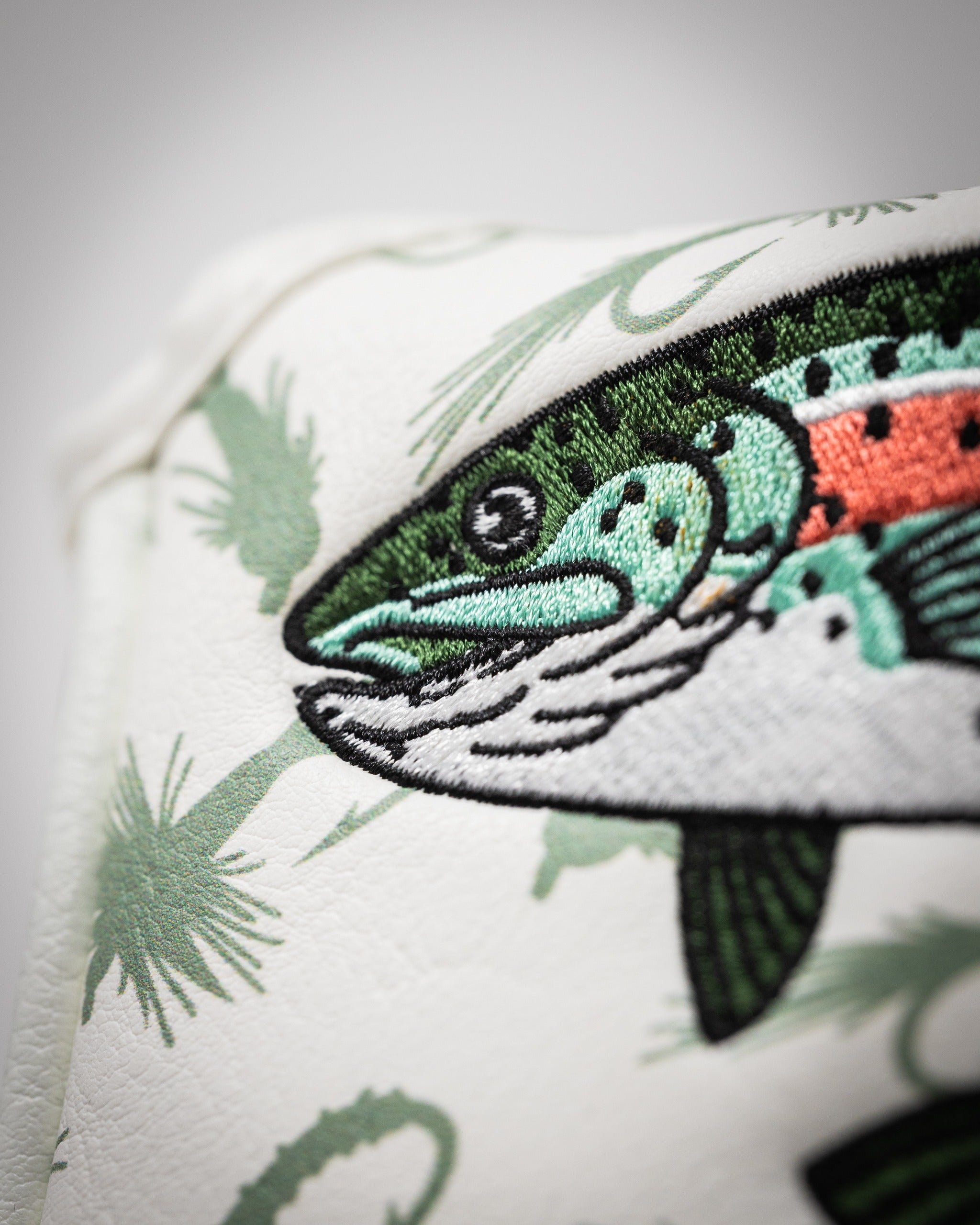 Trout mallet putter cover featuring detailed fish embroidery and a tropical leaf pattern, perfect for stylish golfers.
