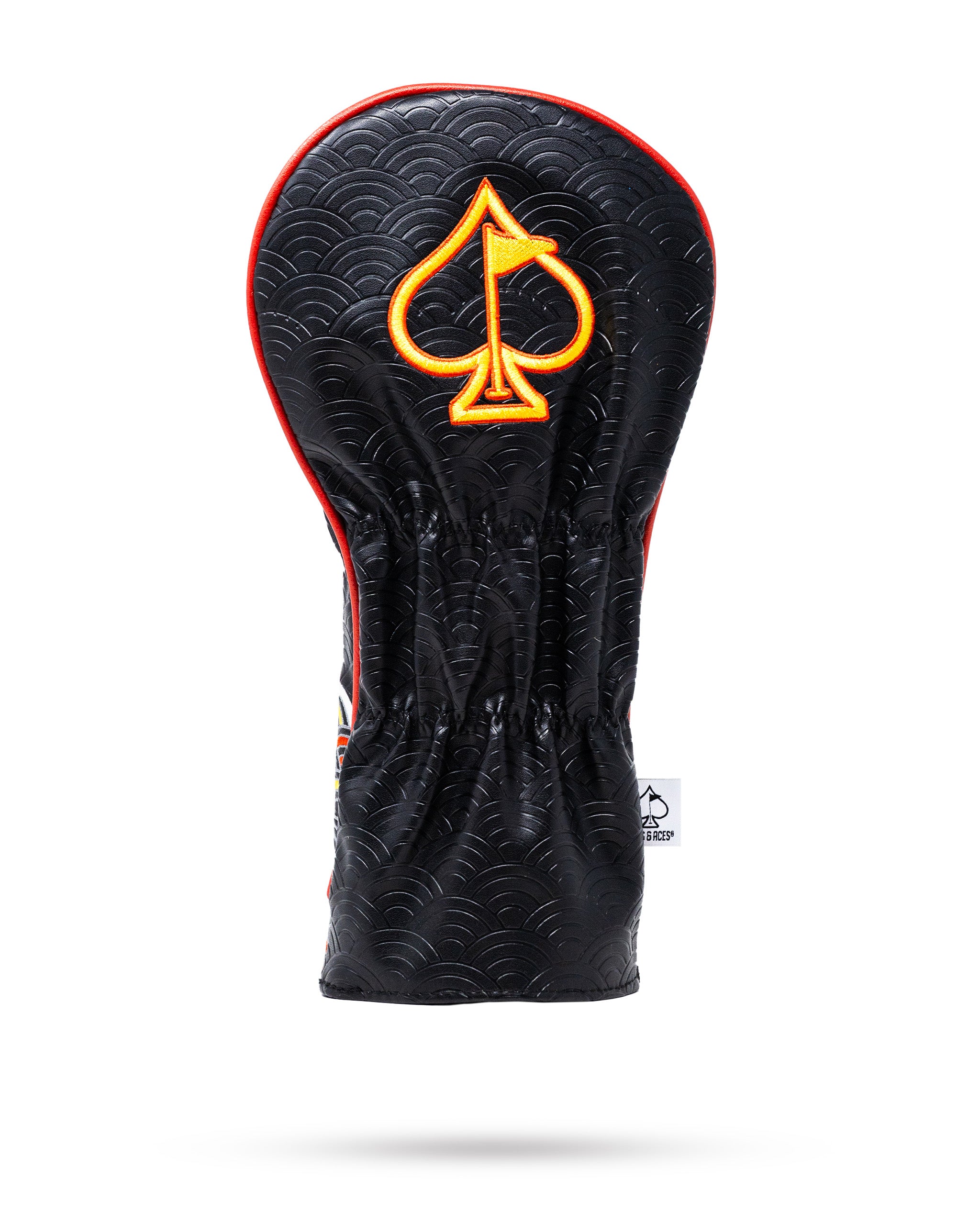 Bold black driver cover featuring a vibrant orange spade logo and a textured wave pattern, perfect for stylish golfers.