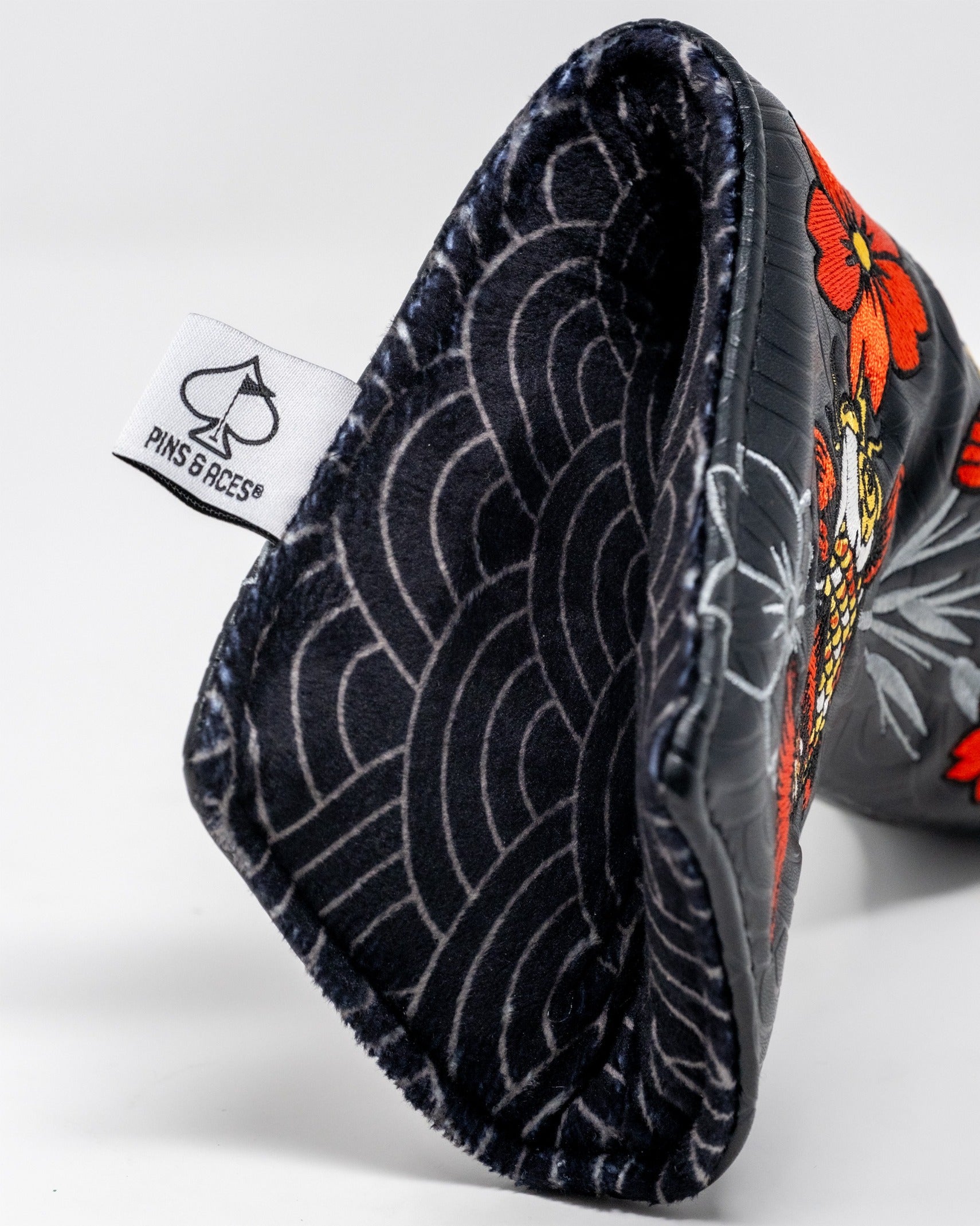 Bold Koi Flow blade putter cover featuring vibrant floral designs and a soft interior lining for protection.